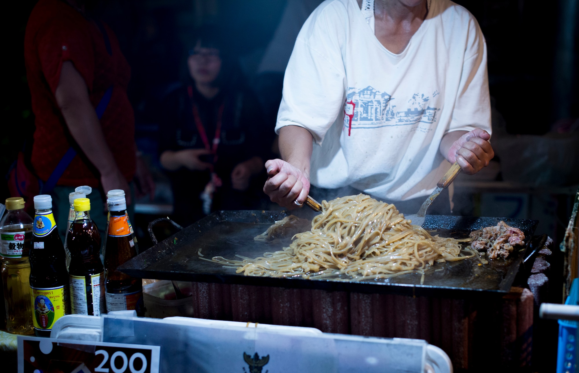 A street vendor cooks noodles at the Fussa Tanabata Festival in Fussa City, Japan, Aug. 8, 2013. Vendors featuring a variety of foods lined the streets for festival participants to enjoy.  (U.S. Air Force photo by Airman 1st Class Meagan Schutter/Released)