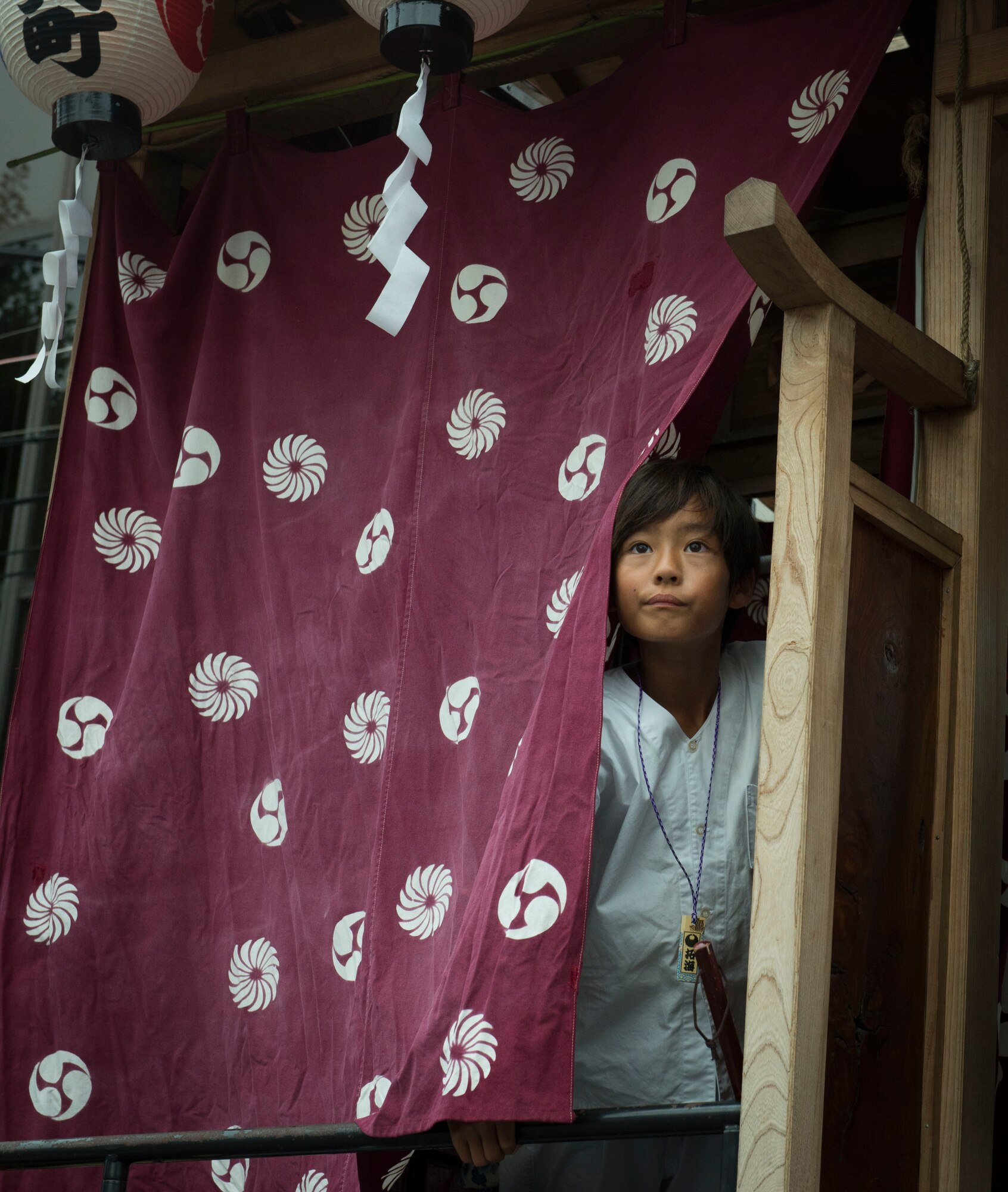 A boy looks out from a mobile stage during the Fussa Tanabata Festival in Fussa City, Japan, Aug. 8, 2013. The stages featured traditional Japanese characters such as the fox and oni, a Japanese demon, as part of the festivities. (U.S. Air Force photo by Airman 1st Class Meagan Schutter/Released)