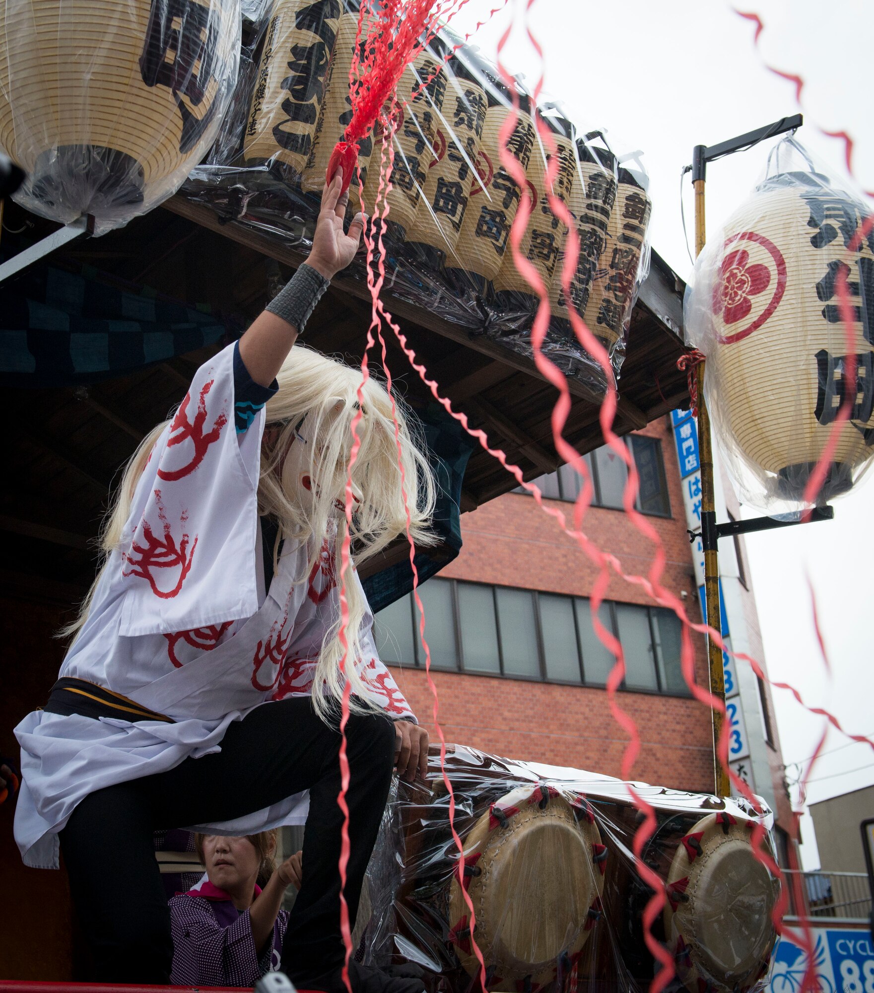 A performer shoots ribbon out to the crowd in Fussa City, Japan, Aug. 8, 2013, during the 64th annual Fussa Tanabata Festival. The festival included traditional Japanese dance performances and groups carrying mikoshi shrines.  (U.S. Air Force photo by Airman 1st Class Meagan Schutter/Released)