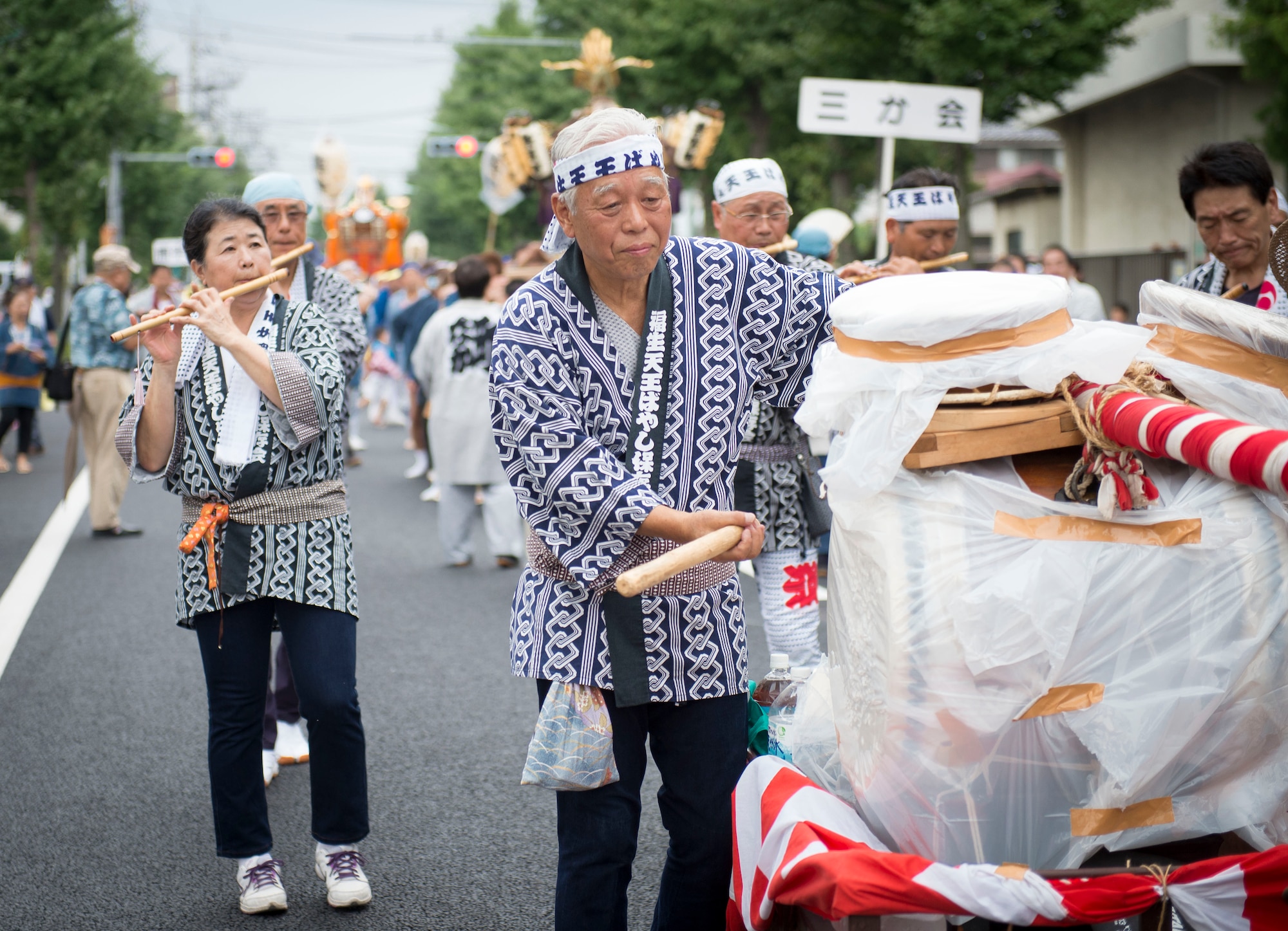 Participants in the Fussa Tanabata Festival parade play instruments as they make their way to Fussa City Hall, Fussa City, Japan, Aug. 8, 2013. Multiple mikoshi shrines were carried from Shinmeisya Shrine to City Hall during the 64th annual Fussa Tanabata Festival.  (U.S. Air Force photo by Airman 1st Class Meagan Schutter/Released)
