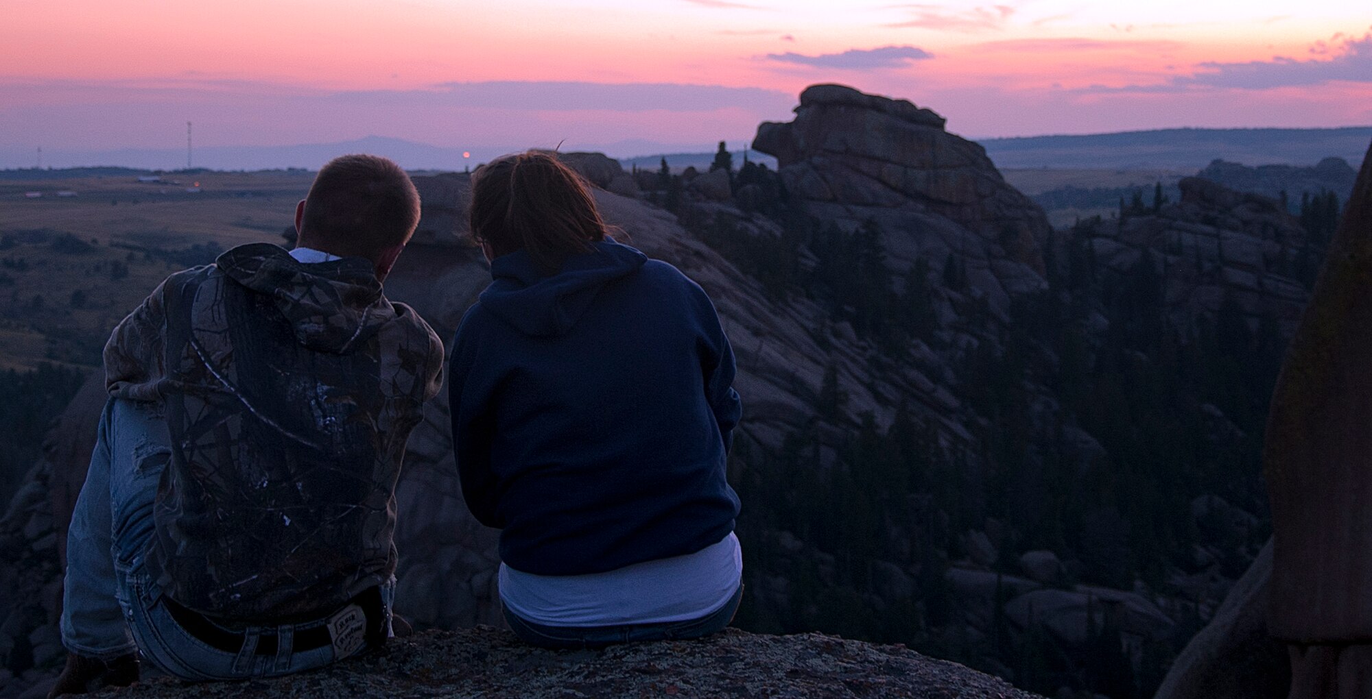 140810-F-GZ967-005 Airman 1st Class AJ Kettinger, 30th Airlift Squadron, and Siobhan Lynch, 90th Medical Group, take in the view from one of the plateaus of Vedauwoo State Park, Wyo., Aug. 10. Vedauwoo offers beginner climbing near the base of the rock formations that do not require gear. (U.S. Air Force photo by Airman 1st Class Brandon Valle)