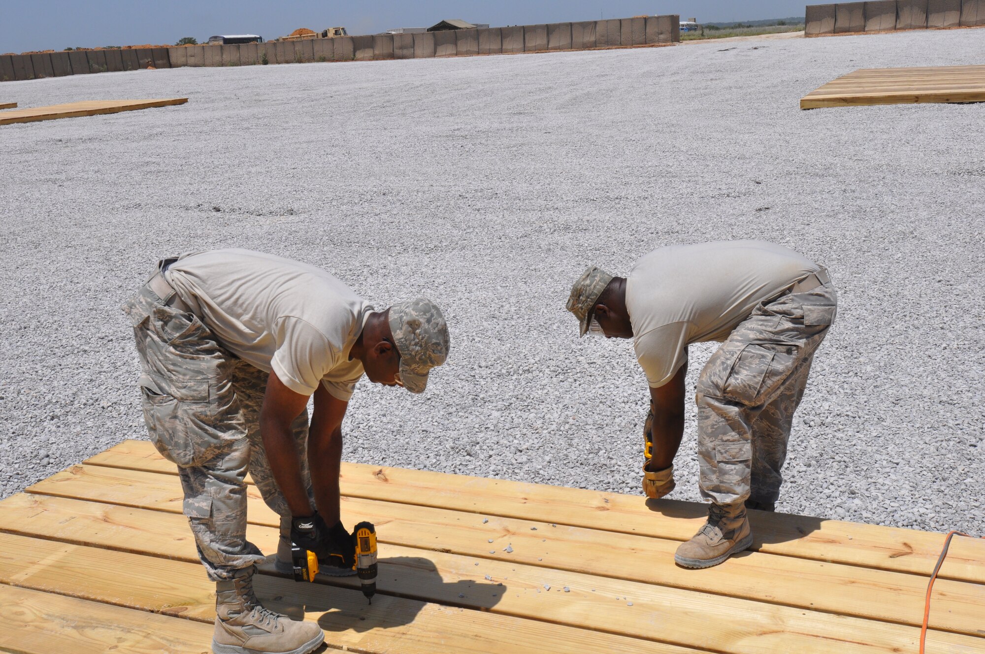 Master Sgt. Ray Bell and Technical Sgt. Benjamin Alexis, 301st Civil Engineering Squadron heating, ventilation and air conditioning technicians, build flooring July 12, 2014, at Fort Wolters. Members of the 301 CES helped construct a five-acre Forward Operating Base in a joint effort with the Texas Army National Guard’s 176th Engineering Brigade. (U.S. Air Force photo by Master Sgt. Mark Orr)