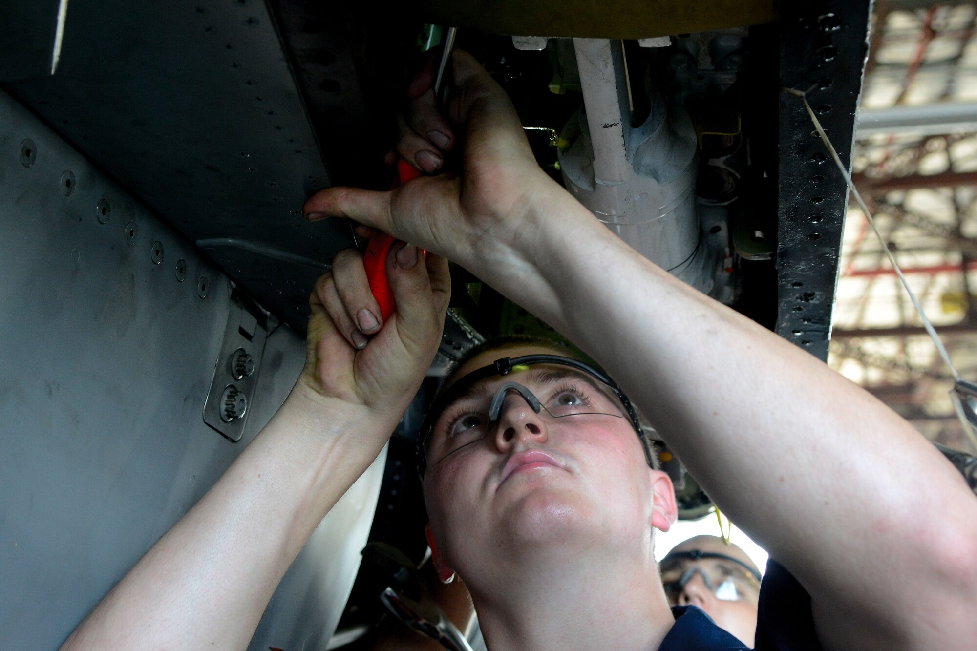 U.S. Air Force Airman 1st Class Elden Ball, 20th Equipment Maintenance Squadron phase inspection team member checks the hydraulic fluid on an F-16CM Fighting Falcon at Shaw Air Force Base, S.C., Aug. 6, 2014. There are approximately 84 fighter jets assigned to the 20th Fighter Wing which are maintained by Airmen to the 20th Aircraft Maintenance Squadron. (U.S. Air Force photo by Senior Airman Ashley Gardner/Released)