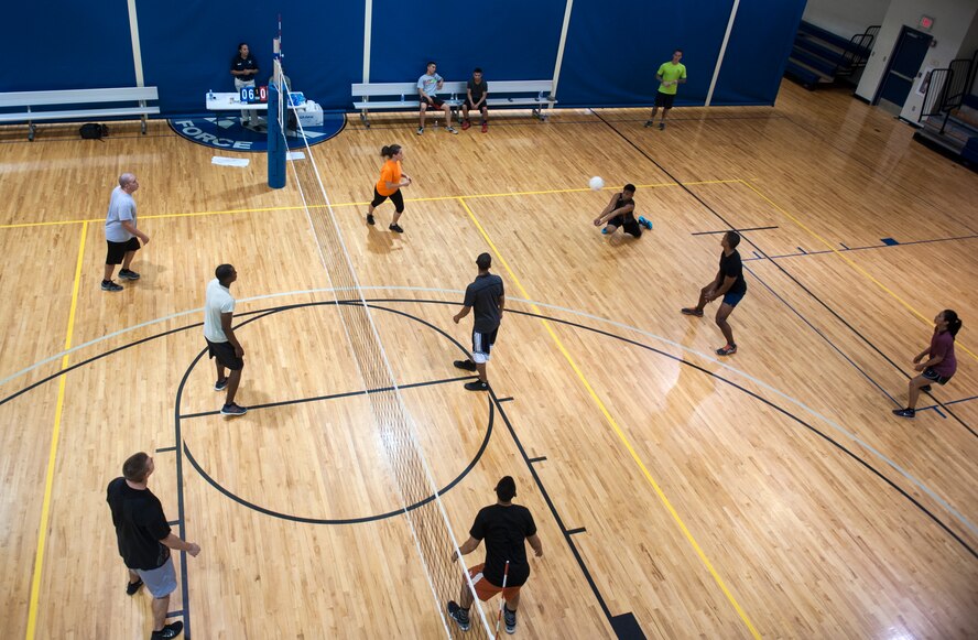 Two teams battle for the win during a volleyball tournament at Moody Air Force Base, Ga., Aug. 8, 2014. The tournament, which was hosted by the Freedom I Fitness Center, was double-elimination style. (U.S. Air Force photo by Senior Airman Jarrod Grammel/Released)
