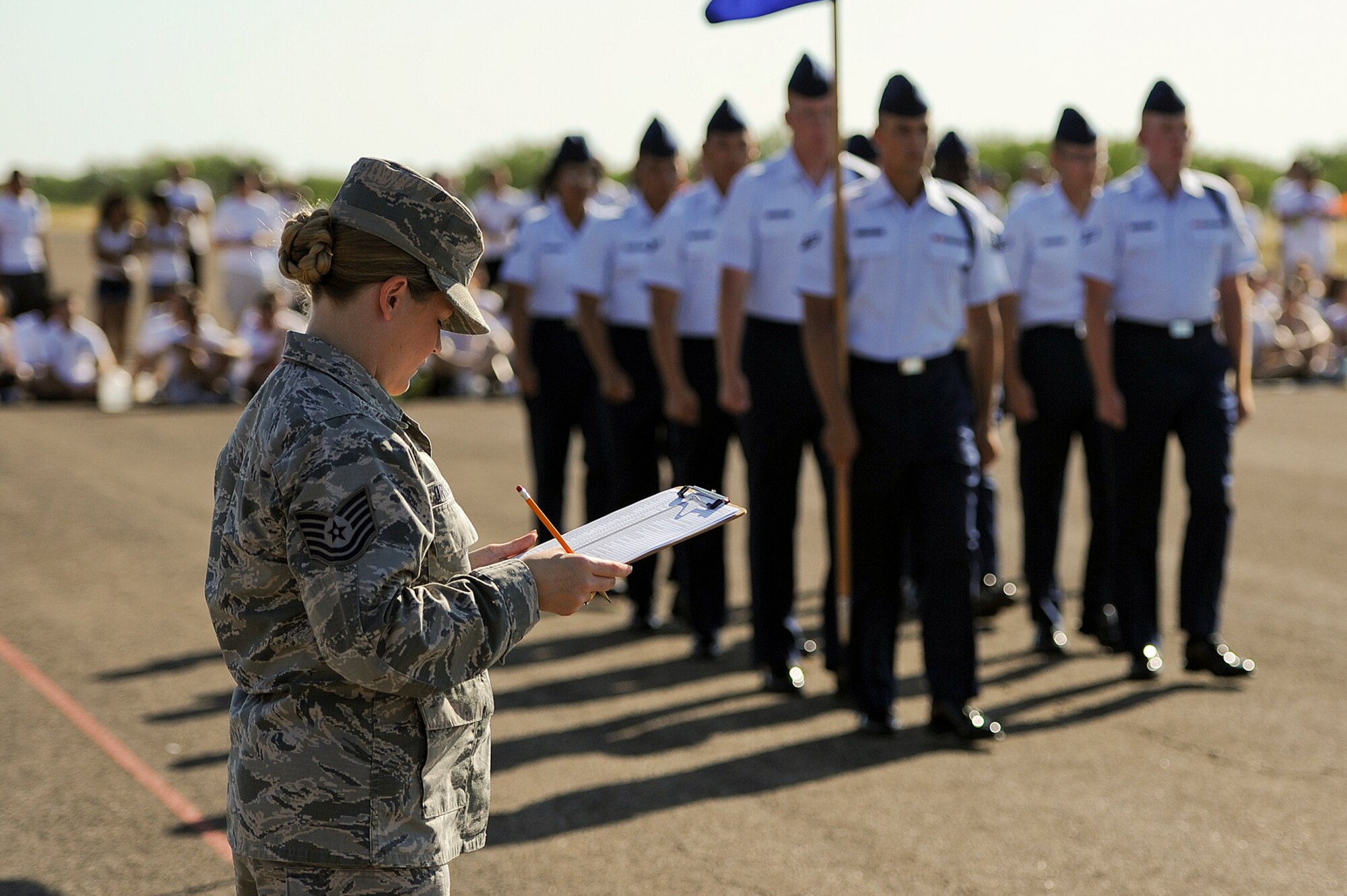 GOODFELLOW AIR FORCE BASE, Texas – Tech. Sgt. Laura E. Dryden, 315th Training Squadron instructor, judges the 315th TRS during the third quarter drill competition on the flight line Aug. 9. The 315th TRS won exhibition and the overall award. (U.S. Air Force photo/ Airman 1st Class Devin Boyer)