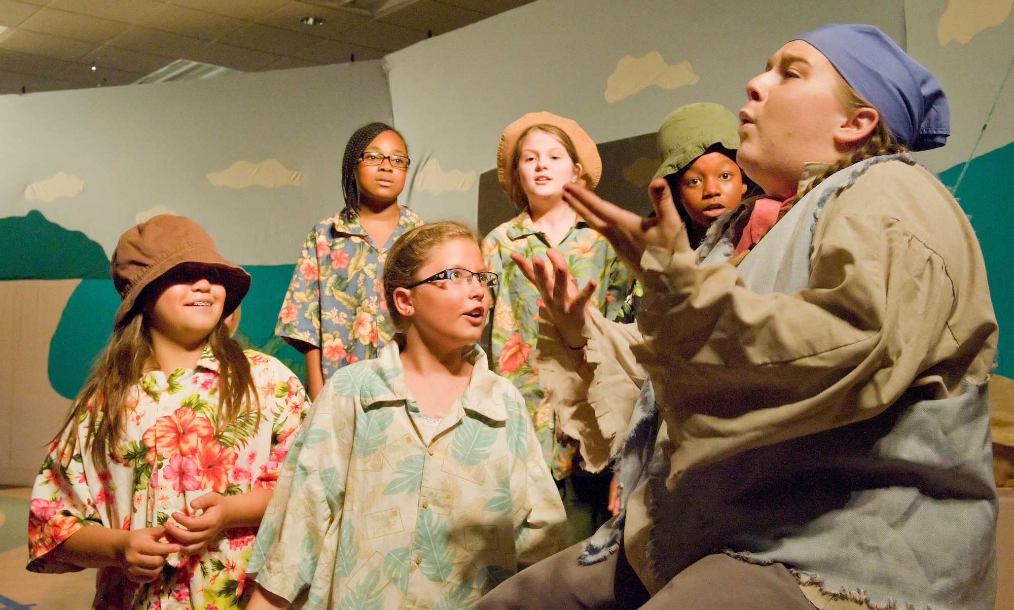 Emilie LaBonte, right, tour actor/director from the Missoula Children's Theatre, Missoula, Montana, acts as Jolly Rodger, performs a scene with the beach bums during "Blackbeard the Pirate" Aug. 8, 2014, at the Youth Center on Dover Air Force Base, Del. LaBonte and 55 cast members from the Youth Center performed to a standing room only crowd. (U.S. Air Force photo/Roland Balik)