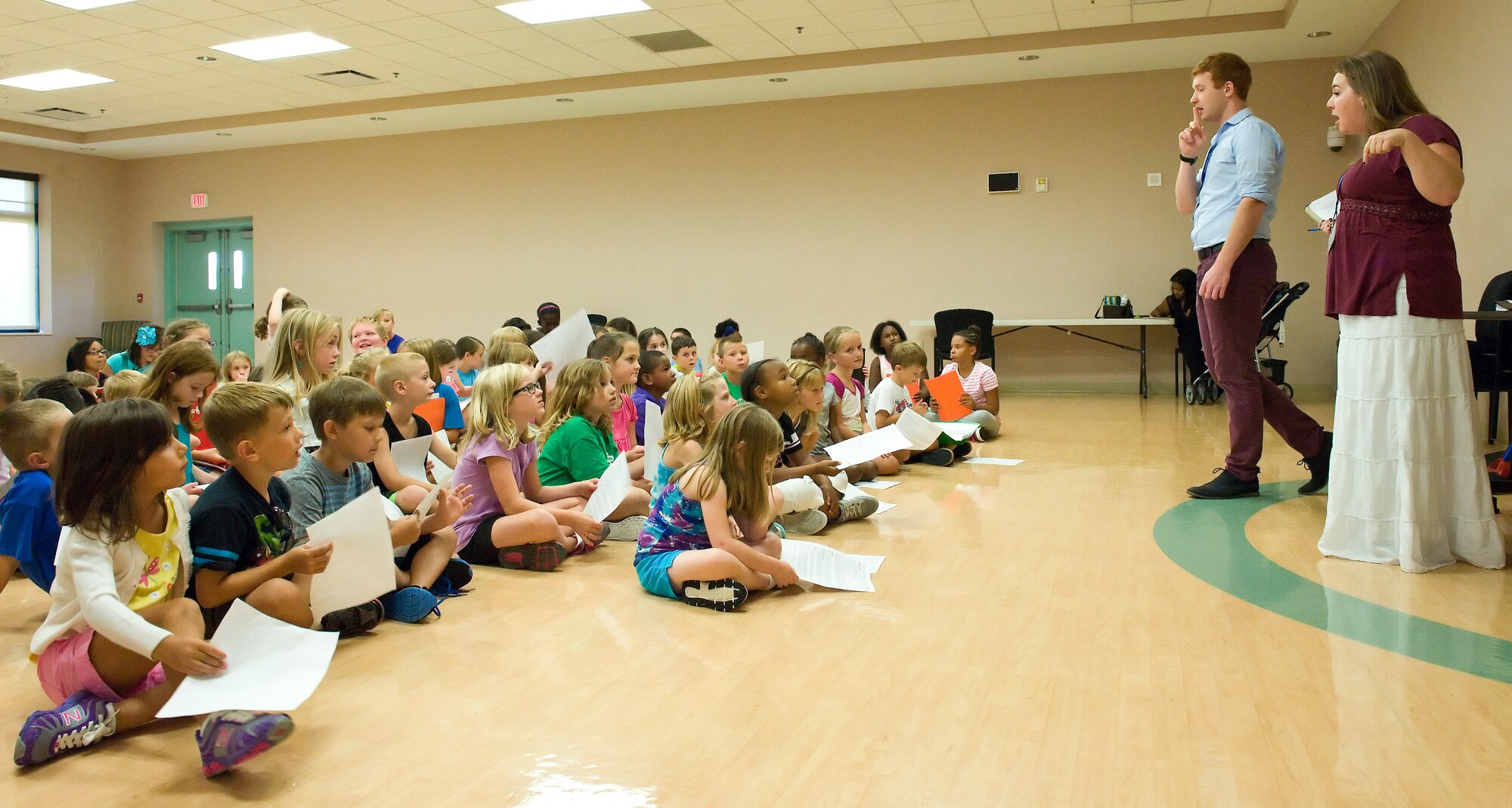 Emilie LaBonte, right, and Cody Freeman, second from right, both tour actor/directors from the Missoula Children's Theatre, Missoula, Montana, talk to children during "Blackbeard the Pirate" auditions Aug. 4, 2014, at the Youth Center on Dover Air Force Base, Del. Seventy-five children auditioned for 55 speaking or choreographed casts for the one-hour long musical. (U.S. Air Force photo/Roland Balik)