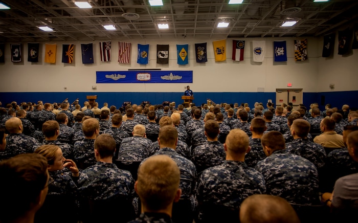 Heisman Trophy winner and former NFL star Herschel Walker shares his story about growing up in Georgia, playing professional football and how he sought help from mental health professionals for his struggles with dissociative identity disorder with Sailors Aug. 6, 2014, at the Joint Base Charleston – Weapons Station, S.C. Walker visited the base to share his story about growing up in Georgia, playing professional football and how he sought help from mental health professionals for his struggles with dissociative identity disorder. Walker spoke and met Sailors and Airmen at both the Weapons Station and Air Base where he met with service members and their families and signed autographs. Walker played college football at the University of Georgia and spent 14 years in the NFL. (U.S. Air Force photo / Senior Airman Tom Brading)

