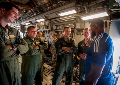Herschel Walker, former NFL football player and Heisman Trophey winner, meets with members of the 16th Airlift Squadron Aug. 6, 2014, at Joint Base Charleston, S.C. (pictured from left: Capt. Steven Holler, Senior Airman Jose Guevara, Capt. Gerald Coscarelli and Capt. Griffin Nevitt.) Walker visited the base to share his story about growing up in Georgia, playing professional football and how he sought help from mental health professionals for his struggles with dissociative identity disorder. Walker spoke and met Sailors and Airmen at both the Weapons Station and Air Base where he met with service members and their families and signed autographs. Walker played college football at the University of Georgia and spent 14 years in the NFL. (U.S. Air Force Photo / Senior Airman Tom Brading)