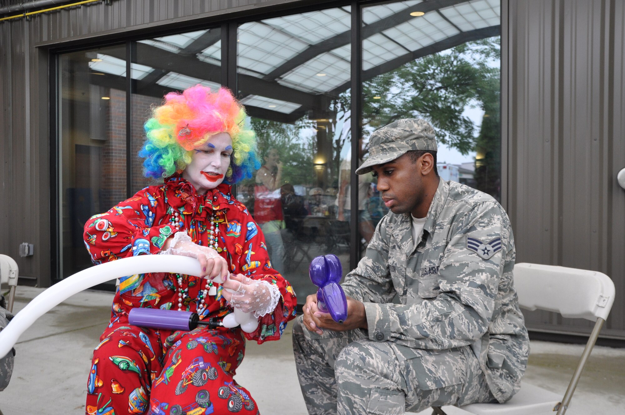 YOUNGSTOWN AIR RESERVE STATION, Ohio – Cindy the Clown shows Air Force Reserve Senior Airman Devonte Winston, assigned to the 910th Airlift Wing’s 910th Force Support Squadron, the art of making balloon animals during the wing’s recent Family Day held here, August 3, 2014. Family day is an installation open house held for 910th Servicemembers and their families, designed to let Reserve families strengthen bonds and experience the home station of their Reservist loved one. U.S. Air Force photo by Master Sgt. Bob Barko Jr.