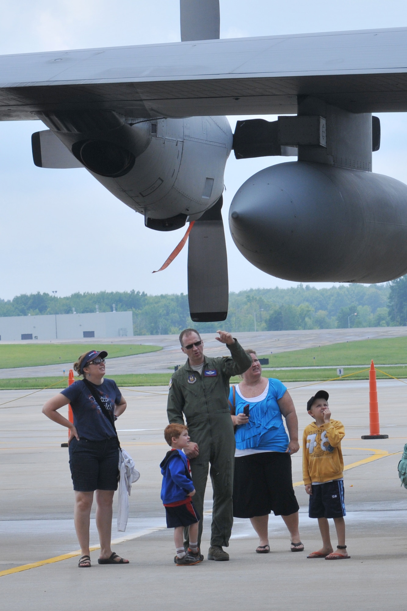 YOUNGSTOWN AIR RESERVE STATION, Ohio – An aircrew member assigned to the Air Force Reserve’s 910th Airlift Wing talks with family members about the C-130 Hercules tactical cargo aircraft they are standing near during the wing’s recent Family Day held here, August 3, 2014. Family day is an installation open house held for 910th Servicemembers and their families, designed to let Reserve families strengthen bonds and experience the home station of their Reservist loved one. U.S. Air Force photo by Tech. Sgt. James Brock.