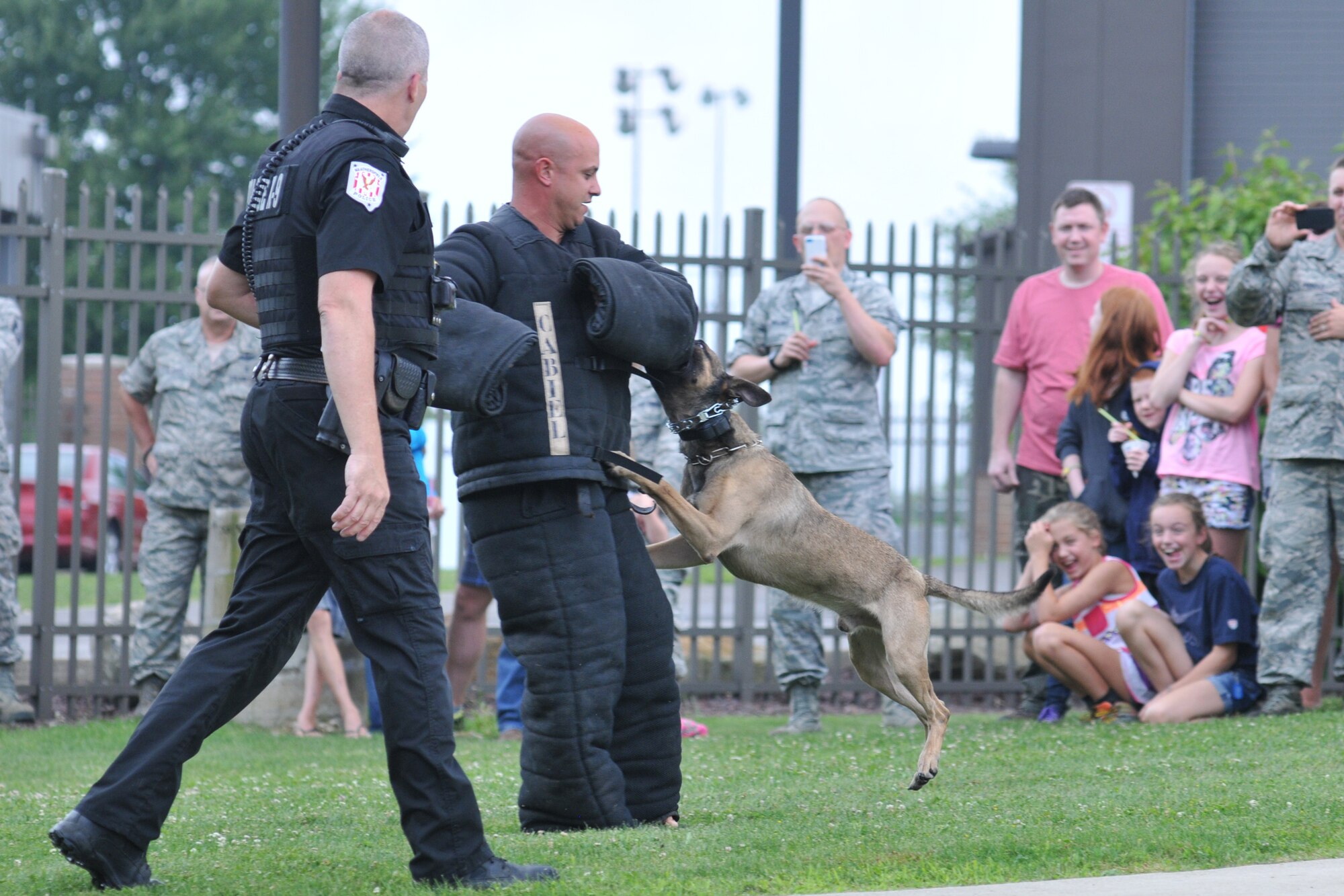 YOUNGSTOWN AIR RESERVE STATION, Ohio – Members of the nearby Weathersfield Police Department work with a K-9 police dog for a demonstration in front of a crowd of Citizen Airmen assigned to the Air Force Reserve’s 910th Airlift Wing and their families during the wing’s recent Family Day held here, August 3, 2014. Family day is an installation open house held for 910th Servicemembers and their families, designed to let Reserve families strengthen bonds and experience the home station of their Reservist loved one. U.S. Air Force photo by Tech. Sgt. James Brock.