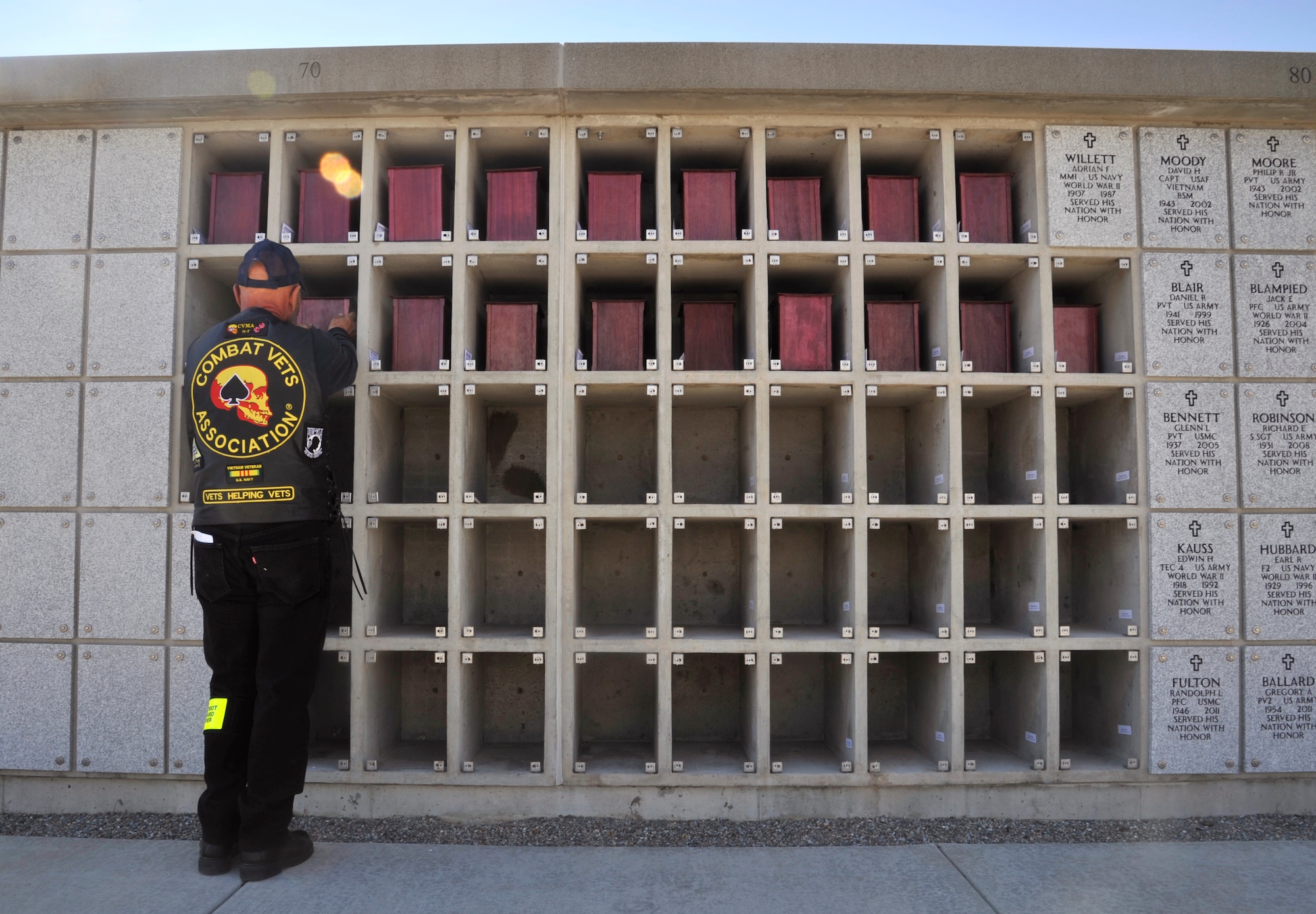A Patriot Guard Rider places an urn in the Columbarium Wall at the Washington State Veterans Cemetery in Medical Lake, Washington, Aug. 8, 2014. Riders from across the nation came to the 4th Annual Missing in America Interment Service here to pay respects to 44 veterans as they were given a final resting place. (U.S. Air Force photo by Senior Airman Mary O'Dell/Released)
