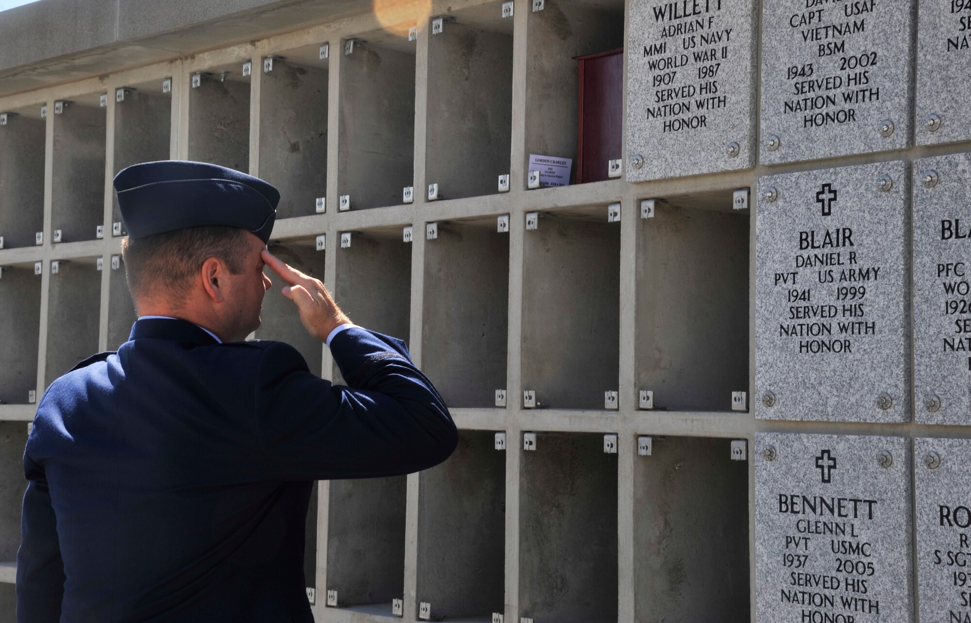 Col. Brian McDaniel renders a salute after placing an urn in the Columbarium Wall at the Washington State Veterans cemetery in Medical Lake, Washington, Aug. 8, 2014. McDaniel attended the ceremony with other members of Fairchild Air Force Base ladership to pay respect to 44 veterans being given a final resting place during the 4th Annual Missing in America Interment Service. McDaniel is the 92nd Air Refueling Wing commander. (U.S. Air Force photo by Senior Airman Mary O'Dell/Released)