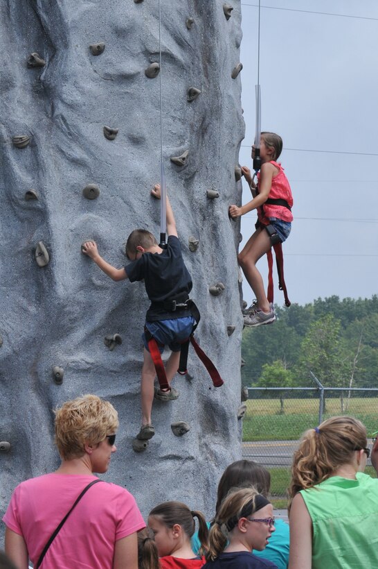 YOUNGSTOWN AIR RESERVE STATION, Ohio – The children of Citizen Airmen assigned to the Air Force Reserve’s 910th Airlift Wing climb a rock wall during the wing’s recent Family Day held here, August 3, 2014. Family day is an installation open house held for 910th Servicemembers and their families, designed to let Reserve families strengthen bonds and experience the home station of their Reservist loved one. U.S. Air Force photo by Tech. Sgt. James Brock.