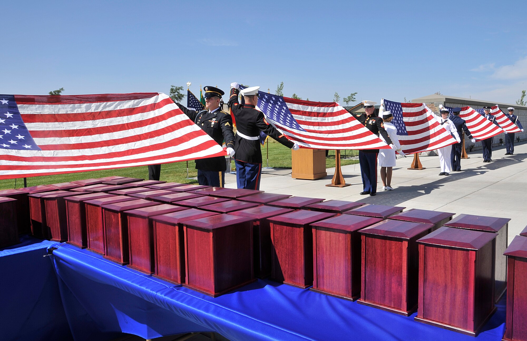 Honor Guard members from each branch of U.S. military service prepare to fold flags prior to the 4th Annual Missing in America Interment Service at the Washington State Veterans Cemetery in Medical Lake, Washington, Aug. 8, 2014. During the ceremony, 44 veterans, unfortunately not claimed by family members, were given a permanent resting place with the help of Patriot Guard Riders, local medical examiners, coroners and funeral homes. (U.S. Air Force photo by Senior Airman Mary O'Dell/Released)
