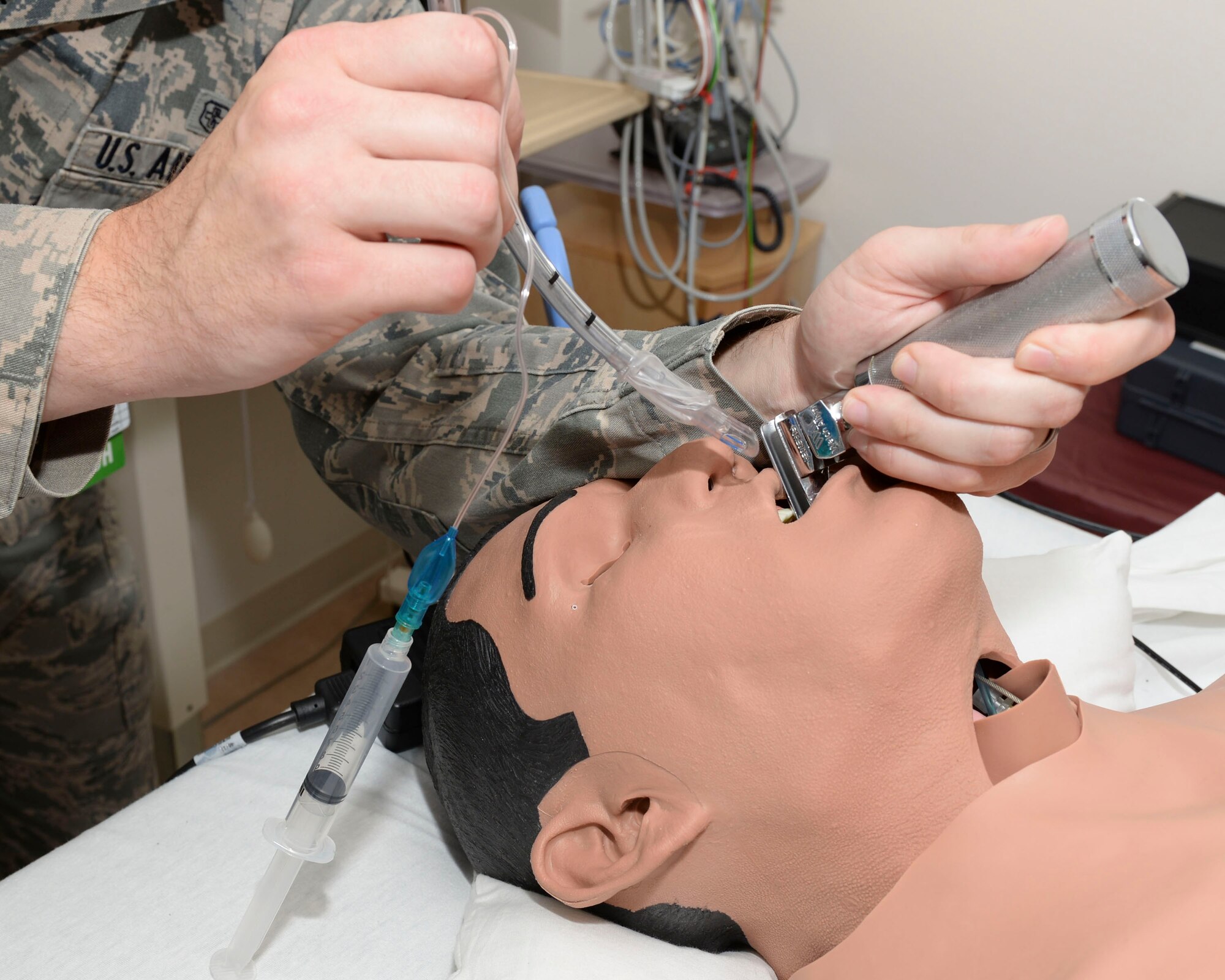 U.S. Air Force Senior Airman Robert Hart, 633rd Medical Operations Squadron cardiopulmonary laboratory technician, intubates a medical mannequin to simulate opening an airway at Langley Air Force Base, Va., Aug. 6, 2014. Intubation is the placement of a tube into the trachea of those who are unconscious or unable to maintain the airway. (U.S. Air Force photo by Senior Airman Connor Estes/Released)