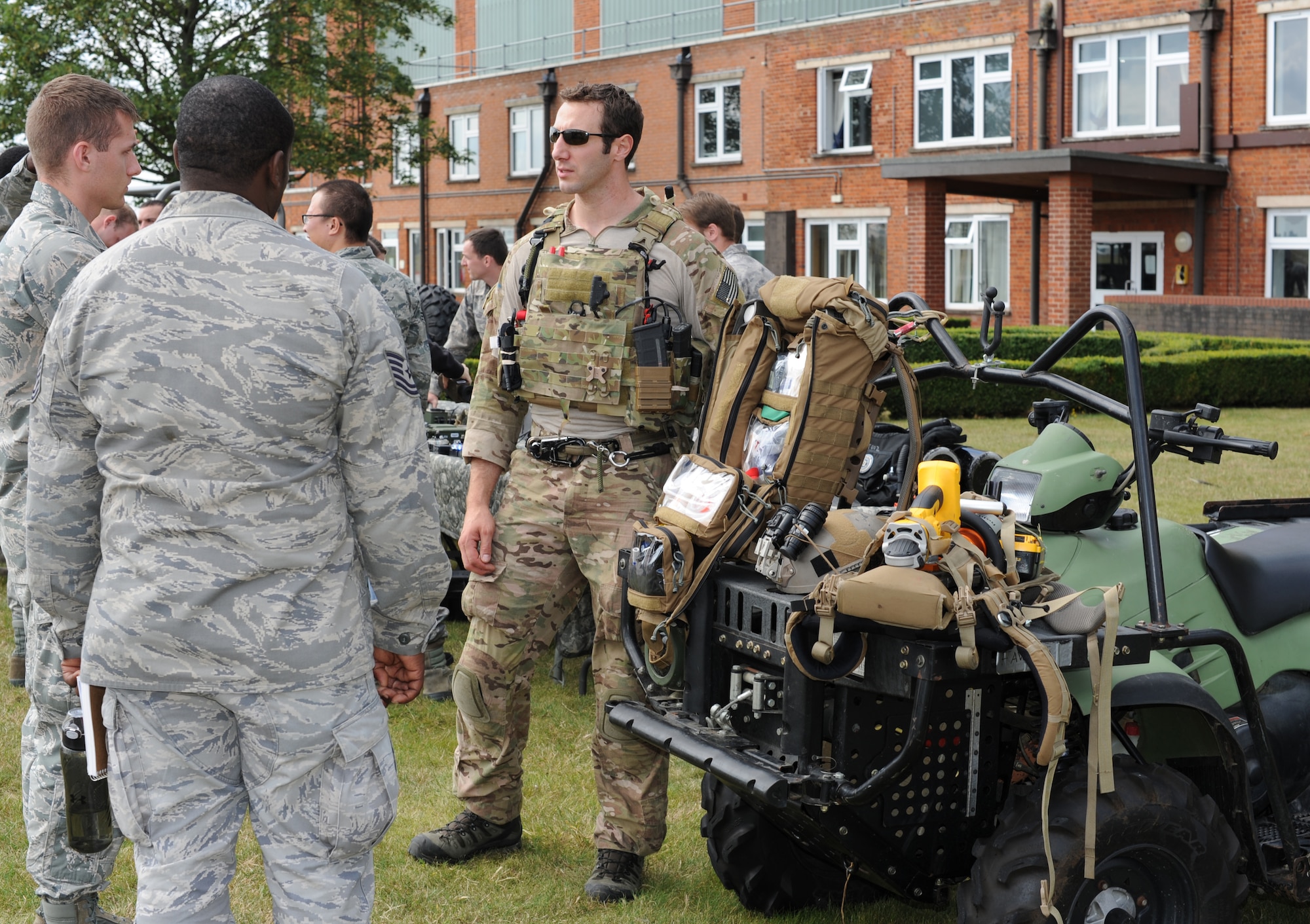 A pararescueman from the 321st Special Tactics Squadron, right, describes to Airmen new to the 352nd Special Operations Group what the roles and responsibilities of PJs are as well as how the integrate with combat controllers and other members of the group, sister services or coalition partners during the Introduction to Special Operations Group event Aug. 7, 2014, outside building 550 on RAF Mildenhall, England. The ISOG event is a class for those new to the 352nd Special Operations Group. Attendees were briefed by all the different elements that comprise 352nd SOG as well as see several aerial platforms and ground equipment special operations forces uses. (U.S. Air Force photo/Tech. Sgt. Stacia Zachary/Released)