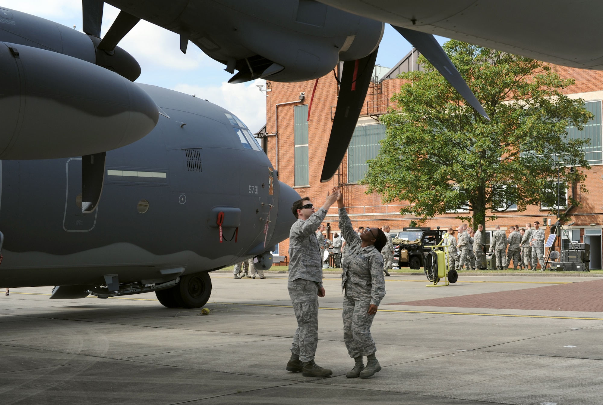 U.S. Air Force Staff Sgt. Ronnie Hunter, left, 352nd Special Operations Maintenance Squadron, explains the difference props used on an MC-130J Commando II to his wife Staff Sgt. Tandalaya Hunter, 100th Logisitcs Readiness Squadron, during the Introduction to Special Operations Group event Aug. 7, 2014, outside building 550 on RAF Mildenhall, England. The ISOG event is a class for those new to the 352nd Special Operations Group, both active-duty members and their family members. Attendees were briefed by all the different elements that comprise 352nd SOG as well as see several aerial platforms and ground equipment special operations forces uses. (U.S. Air Force photo/Tech. Sgt. Stacia Zachary/Released)