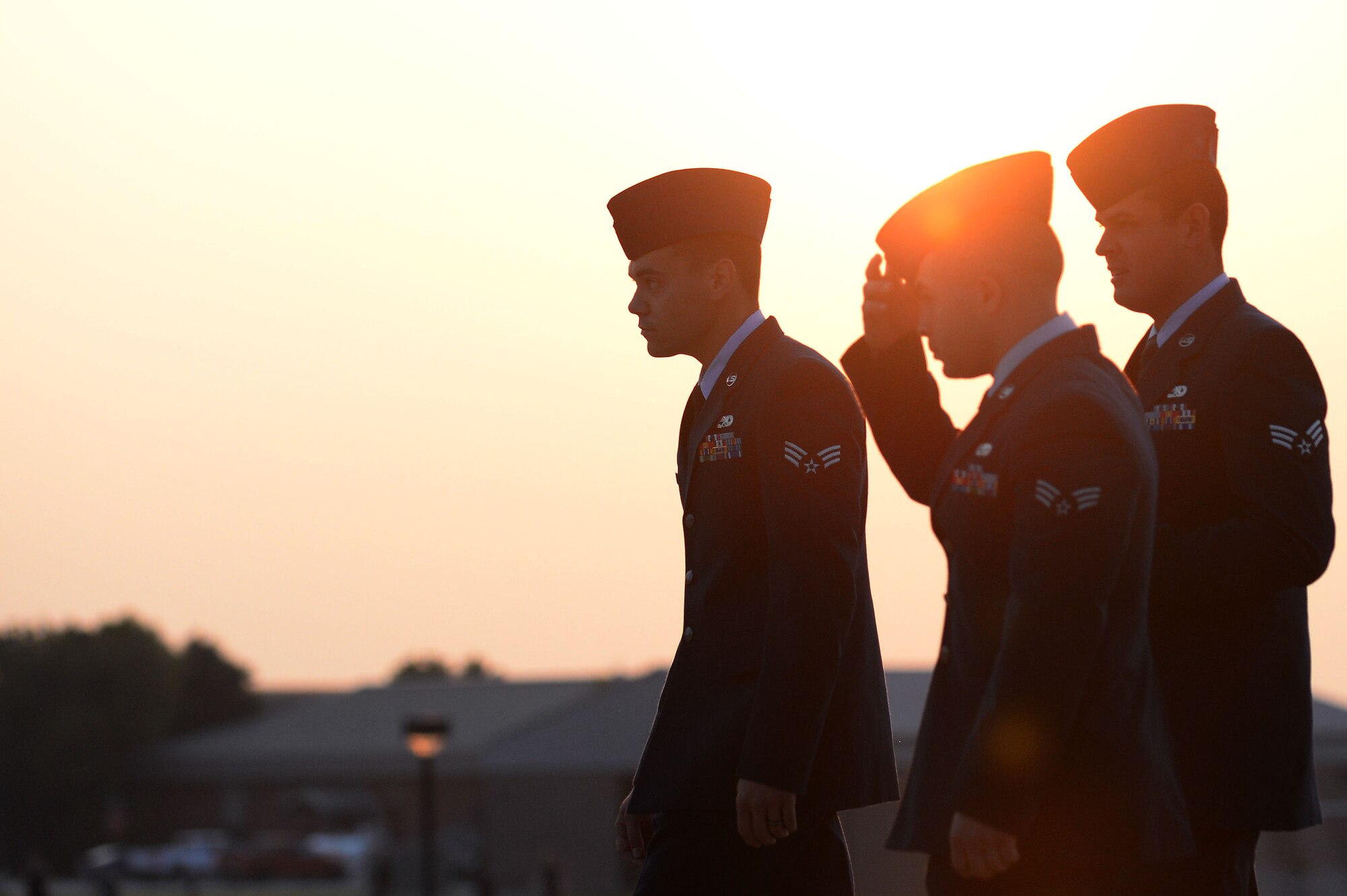 Three U.S. Air Force Airmen assigned to the Senior Master Sgt. David B. Reid Airman Leadership School class 14-6 walk to the drill pad after raising the flag at Shaw Air Force Base, S.C., Aug. 7, 2014. ALS is an in depth leadership course designed to enhance Airmen’s leadership skills while expanding their overall Air Force knowledge. (U.S. Air Force photo by Airman 1st Class Michael Cossaboom/Released)