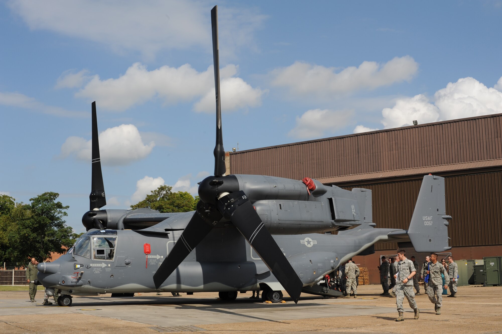 New active-duty members and their family get up close to a CV-22 Osprey during the Introduction to Special Operations Group event Aug. 7, 2014, outside building 550 on RAF Mildenhall, England. The CV-22 is a tiltrotor aircraft used to conduct long-range infiltration, exfiltration and resupply missions for special operation forces. Attendees were briefed by all the different elements that comprise 352nd SOG as well as see several aerial platforms and ground equipment special operations forces uses. (U.S. Air Force photo/Tech. Sgt. Stacia Zachary/Released)