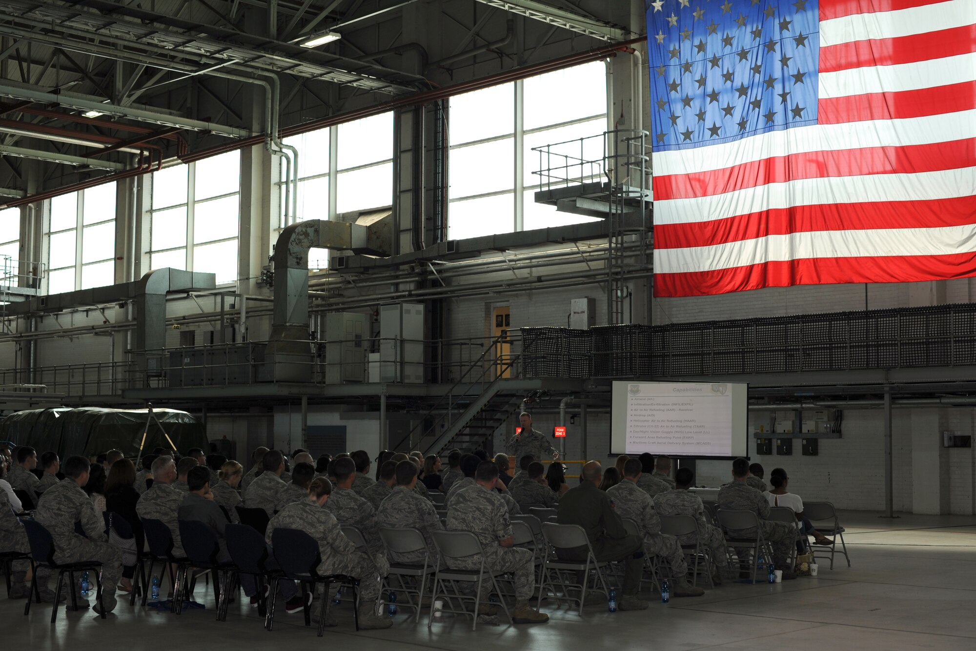 U.S. Lt. Col. John Peak, standing, 67th Special Operations Squadron commander, breaks down what his unit does during the Introduction to Special Operations Group event Aug. 7, 2014, outside building 550 on RAF Mildenhall, England. The 67th SOS operates the MC-130J Commando II to provide precise, reliable, flexible and responsive specialized air mobility. The ISOG event is a class for those new to the 352nd Special Operations Group. Attendees were briefed by all the different elements that comprise 352nd SOG as well as see several aerial platforms and ground equipment special operations forces uses. (U.S. Air Force photo/Tech. Sgt. Stacia Zachary/Released)