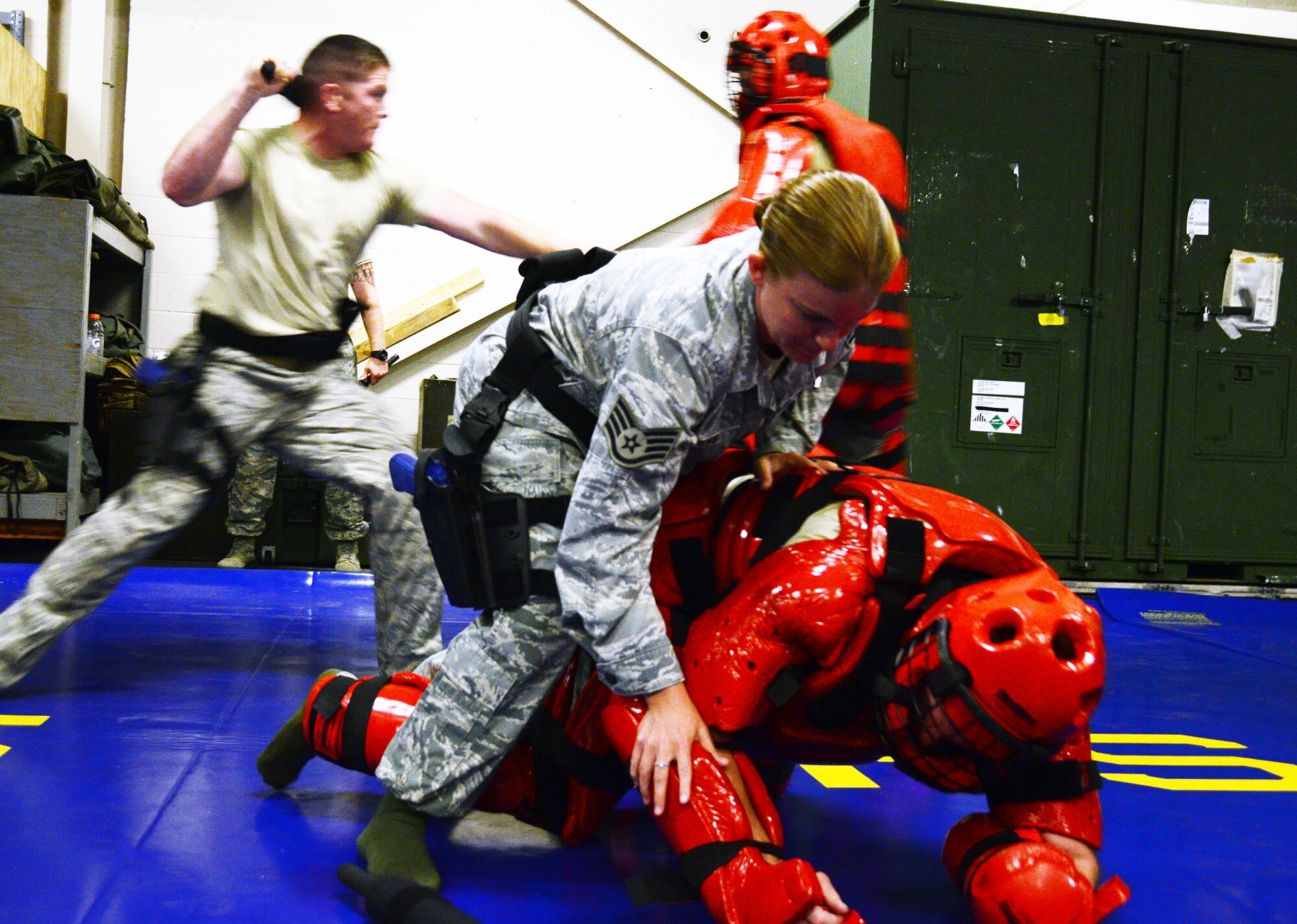 WRIGHT-PATTERSON AIR FORCE BASE, Ohio - Staff Sgt. Dawn Gettys and Senior Airman Kyle Altman, both ssigned to the 445th Security Forces Squadron, practice subduing perpetrators during the use of force training, July 13, 2014 here. The 445 SFS conducts training through a scenario-based course on de-escalating conflict by using verbal commands, simulating use of pepper spray, batons or deadly force. The annual training ensures the squadron is proficient and maintains operational readiness. (U.S. Air Force photo/Senior Airman Devin Long)