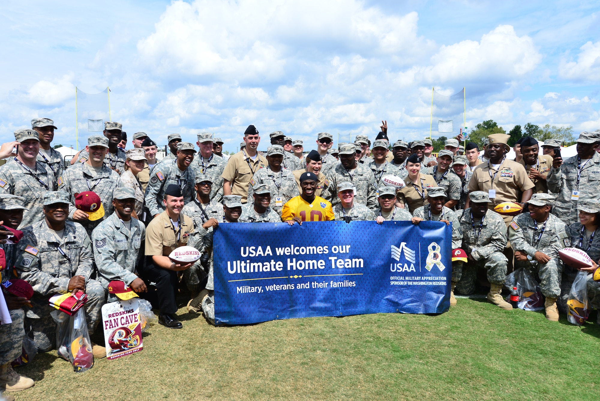 More than 110 U.S. Service members from Joint Base Langley-Eustis, Naval Air Station Oceana and Fort Lee, Va., attended a Washington Redskins training camp practice in Richmond, Va., Aug. 11, 2014. The Service members watched the practice from the field sidelines, and met with team players. (U.S. Air Force photo by Senior Airman Aubrey White/released)