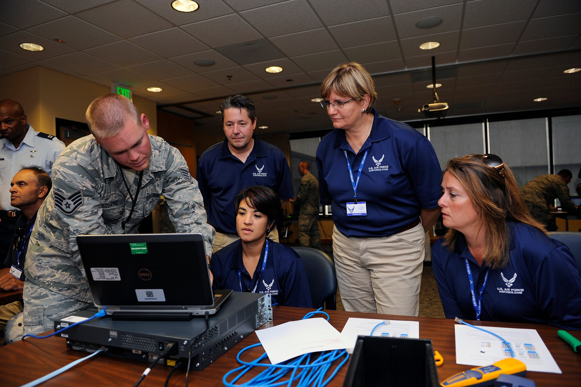 Staff Sgt. Charles Osbourne, 50th Space Communications Squadron, discusses network security with teachers (L-R) Naomi Edwards, Charlene Getz, and Darcie Starkfregoe during an Air Force Recruiting Service sponsored visit here, Monday.  The visit allowed tens of FIRST educators from across the nation to highlight the many STEM opportunities within the Air Force.  (U.S. Air Force photo/Christopher DeWitt)