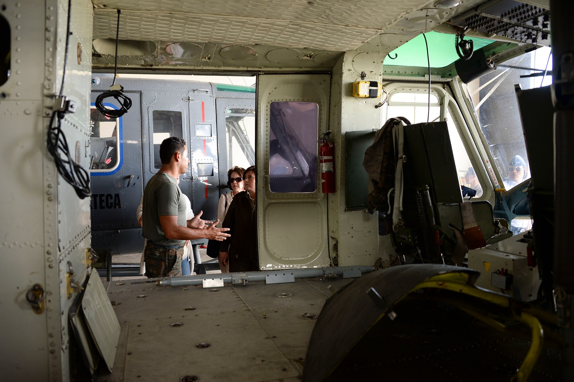A maintenance technician with the Guatemalan air force briefs members of 12th Air Force (Air Forces Southern) and the Arkansas Air National Guard on the Bell UH-1, which is used for air evacuation, during a subject matter expert exchange with the Guatemalan Military in Guatemala City, Guatemala, Aug. 6, 2014.  The briefing informed the U.S. medical technicians of the Guatemalan air force’s aerospace medical capabilities. (U.S. Air Force photo by Tech. Sgt. Heather R. Redman/Released)