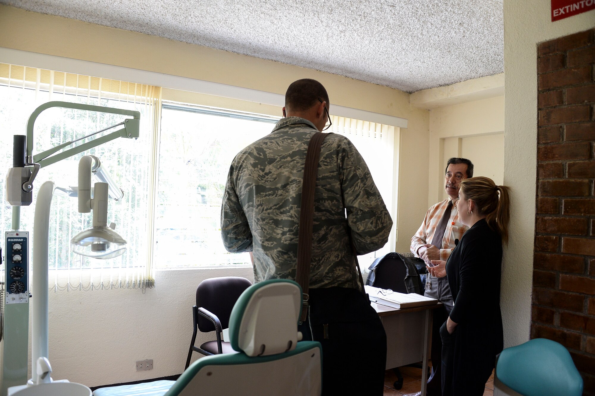 Maj. Joshua Vess, assigned to the 12th Air Force (Air Forces Southern) Surgeon General International Health Specialist team, discuss the dental process with the Guatemalan air force’s dentist during a subject matter expert exchange with the Guatemalan Military in Guatemala City, Guatemala, Aug. 4, 2014. Part of the SMEE event focused on educating the Guatemalan air force on individual readiness, which includes dental. (U.S. Air Force photo by Tech. Sgt. Heather R. Redman/Released)