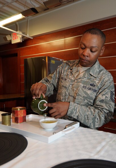 Tech. Sgt. Joseph Holton pours tea in the USO lounge at the Charles C. Carson Center for Mortuary Affairs, Dover Air Force Base, Del., Aug. 12, 2014, for fellow deployers from the 512th Memorial Affairs Squadron to sample. Holton introduced the benefits of drinking tea on his last rotation to the mortuary and plans to start up classes again. (U.S. Air Force photo/Master Sgt. Christopher Gish) 