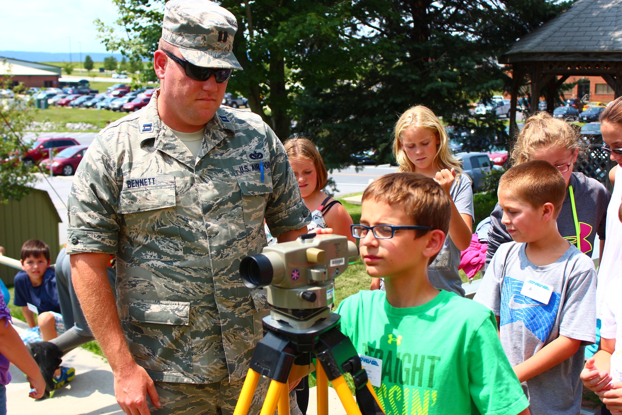Capt. Blake Bennett, the 167th environmental manager, shows STARBASE Kids campers how to check ground elevation and slope using a level gun, Wednesday, July 30 at the 167th Airlift Wing in Martinsburg, W.Va. (Air National Guard photo by Senior Airman Nathanial Taylor.)