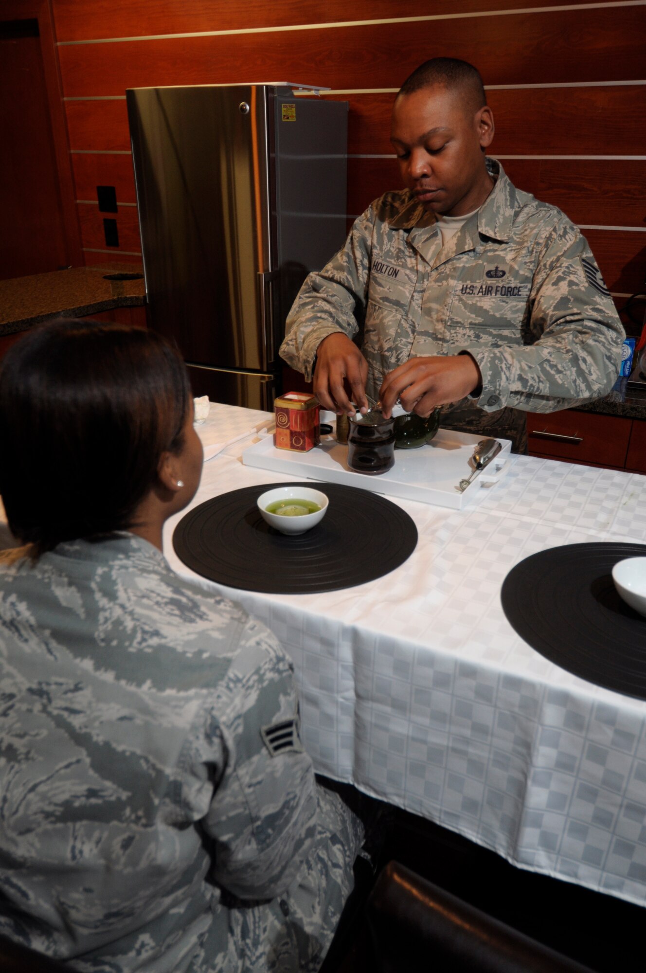 Tech. Sgt. Joseph Holton prepares tea in the USO lounge at the Charles C. Carson Center for Mortuary Affairs, Dover Air Force Base, Del., Aug. 12, 2014, for fellow deployers from the 512th Memorial Affairs Squadron here. Holton introduced the benefits of drinking tea on his last rotation to the mortuary. (U.S. Air Force photo/Master Sgt. Christopher Gish) 