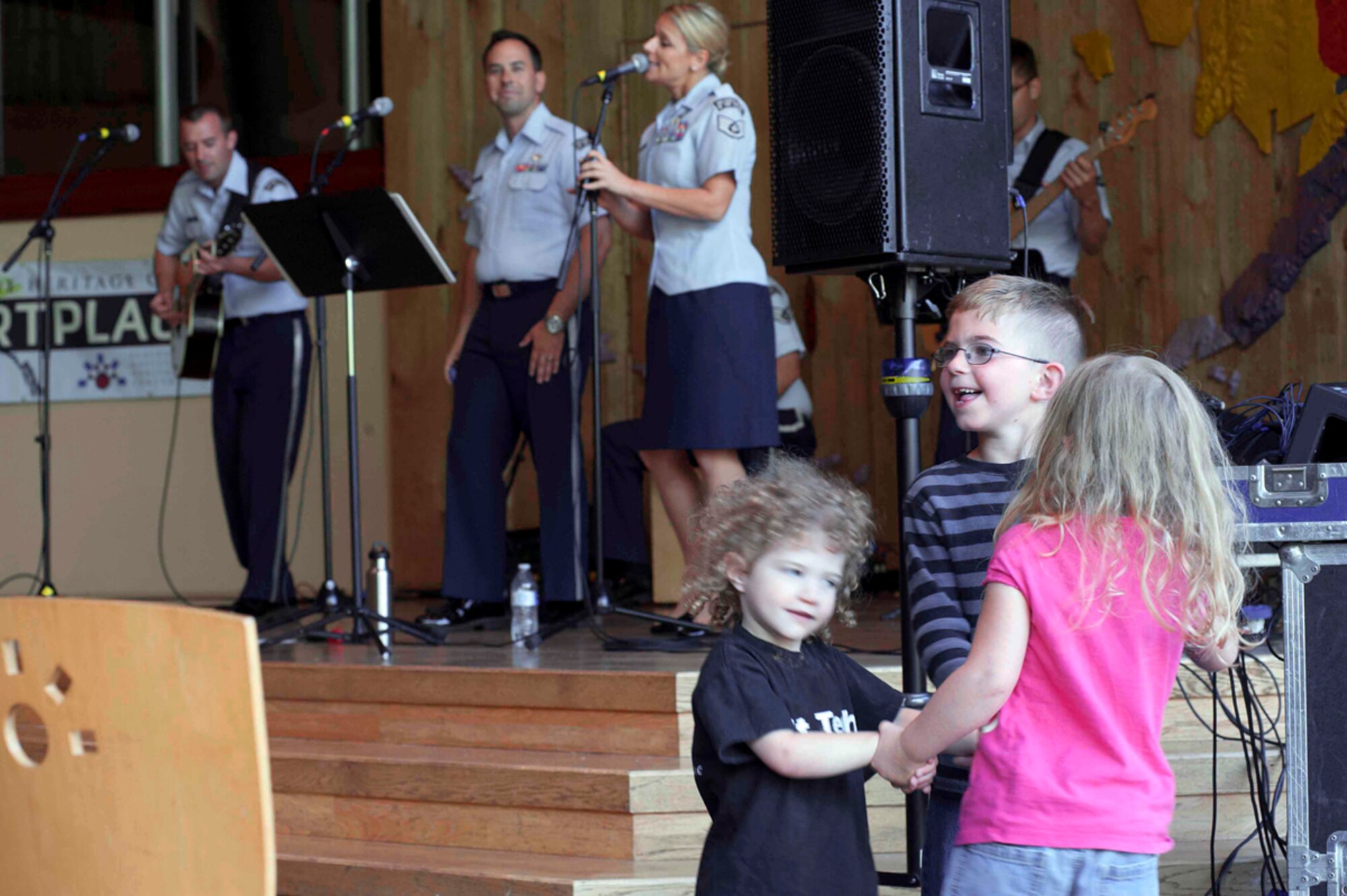 The Band of the Pacific performed at the Alaska Native Heritage Center July 30, 2014. The Air Force Band of the Pacific left JBER last year and moved to Hawaii, but their enduring popularity made a week-long return with several stops a hit with Alaskans. The Airmen performed in downtown Anchorage's Friday0night live music lineup and at the Loussac Library, as well as at the Arctic Thunder Open House and in Talkeetna. (U.S. Air Force photo illustration/Staff Sgt. Robert Barnett and Staff Sgt. William Banton)