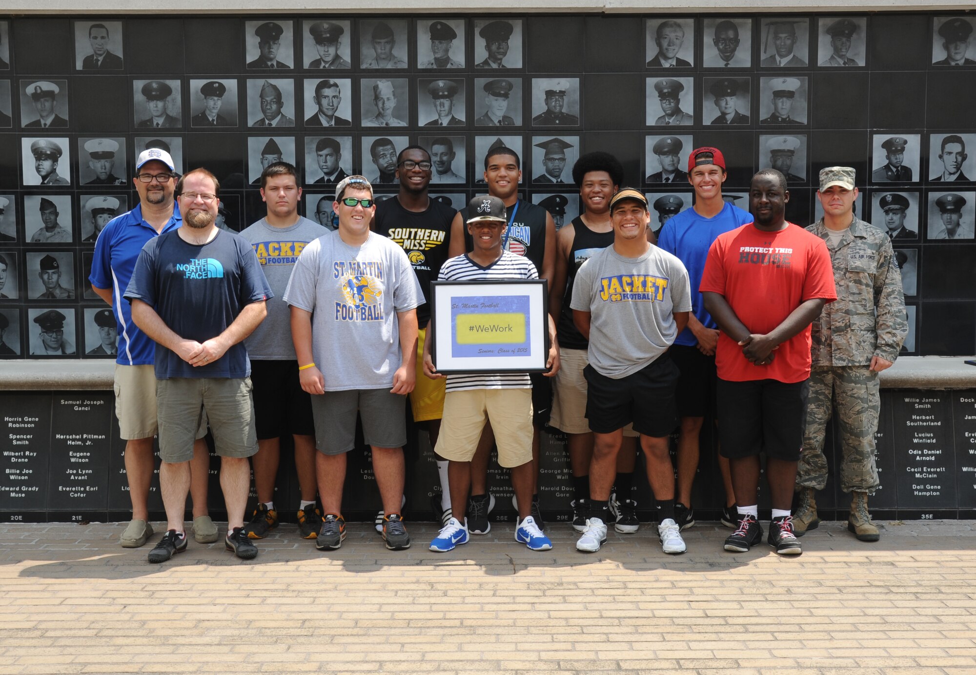 Keesler personnel take a photo with St. Martin High School senior football players during a leadership seminar Aug. 9, 2014, at the Mississippi Vietnam Veterans Memorial in Ocean Springs, Miss. The seminar was a collaboration of the St. Martin Gridiron Club and Keesler personnel, who briefed the seniors on good attitudes, values, beliefs and teamwork.  (Courtesy photo by Kemberly Groue)