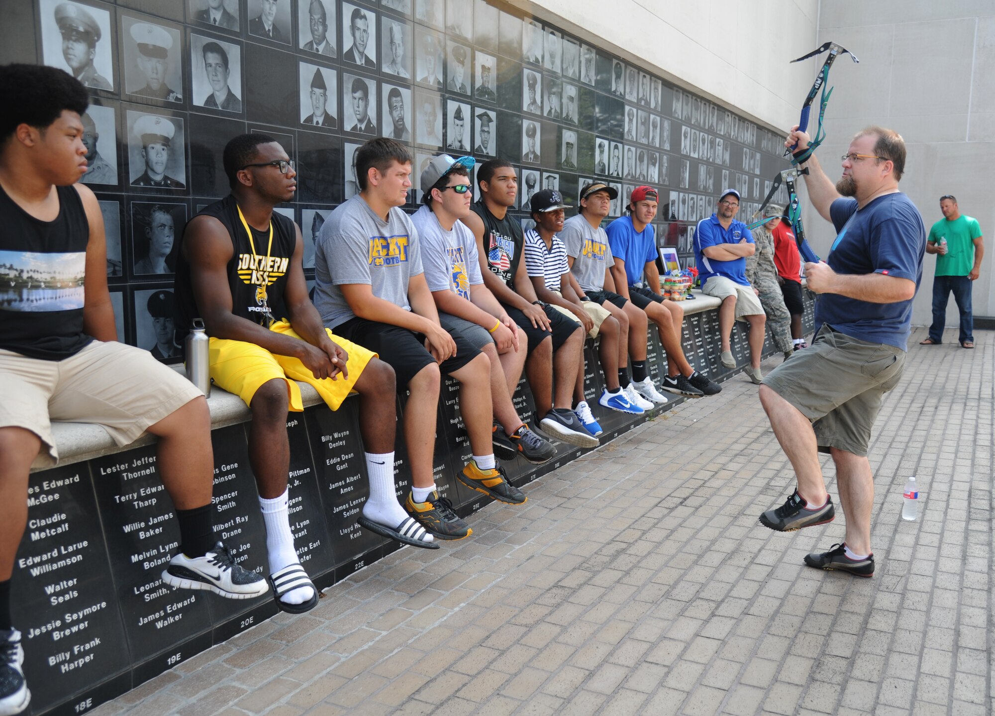 Jason Hall, professional mountain climber and son of Retired Chief Master Sgt. Stanley Hall, shares a personal experience to help explain the importance of being a team player  to St. Martin High School senior football players during a leadership seminar Aug. 9, 2014, at the Mississippi Vietnam Veterans Memorial in Ocean Springs, Miss. The seminar was a collaboration of the St. Martin Gridiron Club and Keesler personnel, who also briefed the seniors on good attitudes, values, beliefs and teamwork.  (Courtesy photo by Kemberly Groue)