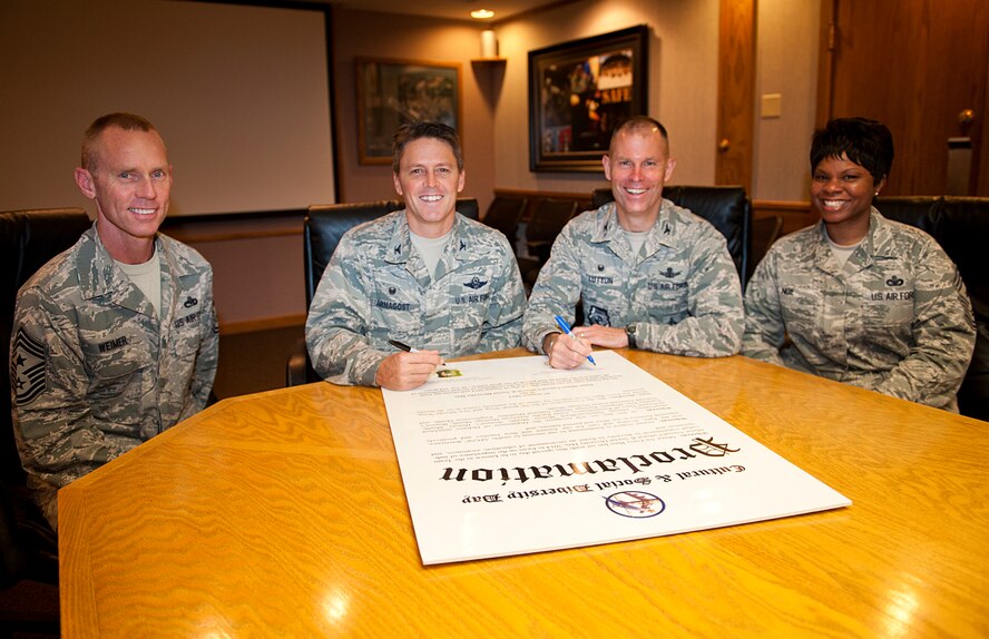 Leadership from the 5th Bomb Wing and 91st Missile Wing pose for a photo during the signing of the Diversity Day proclamation on Minot Air Force Base, N.D., Aug. 7, 2014. The annual event featured food, entertainment and items from different cultures. (U.S. Air Force photo/Airman 1st Class Apryl Hall)