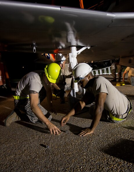 Maintenance group Airmen use bolts to secure an aircraft at the President George W. Bush Air Park at Moody Air Force Base, Ga., Aug. 8, 2014. Airmen towed the newly painted T-33 Shooting Star from the base’s flightline to the air park over night to avoid disrupting traffic. (U.S. Air Force photo by Airman 1st Class Sandra Marrero/Released) 
