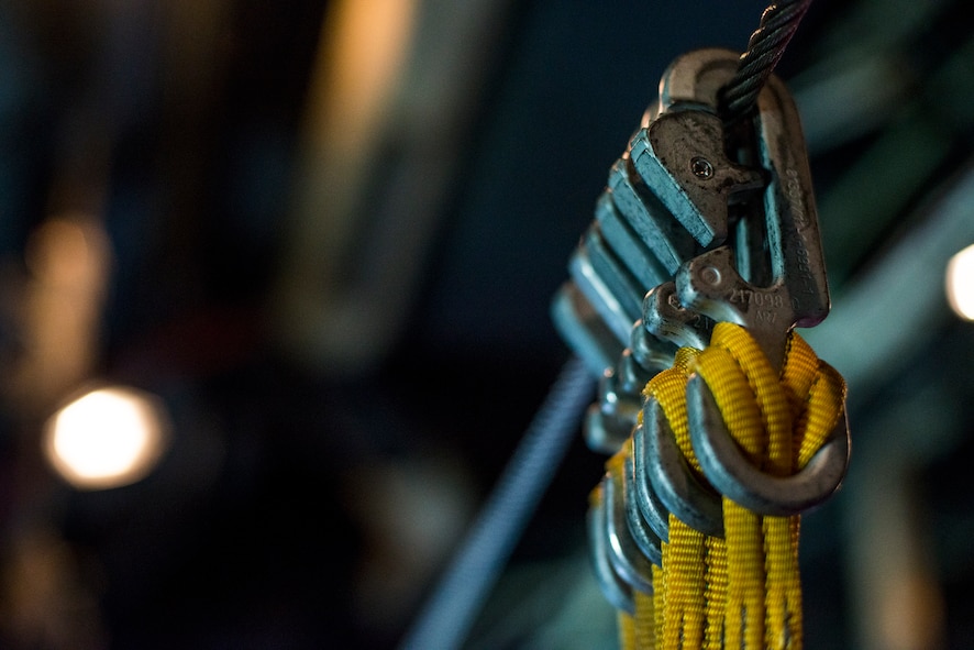 Parachute static lines hang from a cable inside an HC-130P Combat King over Tifton, Ga., Aug. 7, 2014. A static line is attached to the aircraft and automatically deploys the jumpers’ parachute after they’ve jumped. (U.S. Air Force photo by Airman 1st Class Ryan Callaghan/Released)