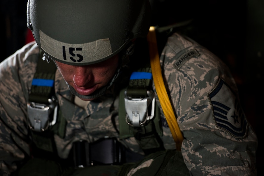 U.S. Air Force Master Sgt. Justin Geers, 823d Base Defense Squadron jumpmaster, waits onboard an HC-130P Combat King for a static-line jump over Tifton, Ga., Aug. 7, 2014. As a jumpmaster, Geers is responsible for inspecting all of the jump gear including each of the jumpers’ parachutes and safety equipment on the aircraft. (U.S. Air Force photo by Airman 1st Class Ryan Callaghan/Released)