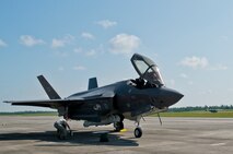 A 33rd Fighter Wing pilot exits an F-35A Lightning II as a 919th Special Operations Wing C-145 begins a take-off roll at Duke Field, Fla., Aug. 6.  The joint strike fighter’s first visit to the reserve base was to participate in a joint major accident response exercise between the 33rd FW, 919th SOW and the 96th Test Wing.  (U.S. Air Force photo/Tech. Sgt. Sam King)