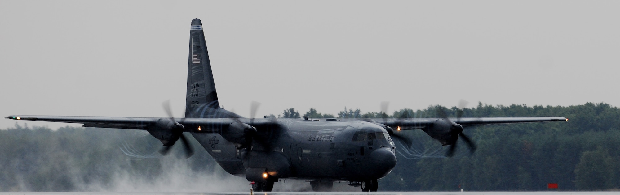 A C-130J Super Hercules touches down before immediately taking off again during a training flight at Powidz Air Base, Poland, Aug. 11, 2014. During this flying training deployment, in support of Operation Atlantic Resolve, C-130 crews were able to hone their skills throughout a multitude of weather conditions. (U.S. Air Force photo by Staff Sgt. Jarad A. Denton/Released)