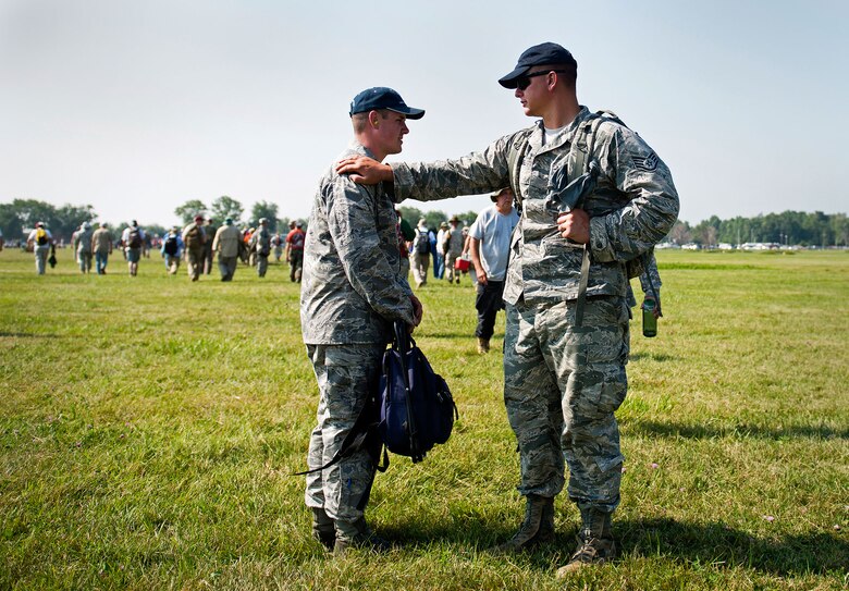 Staff Sgt. Timothy Hessel (right) and Special Agent David Ohlinger talk and compare scores during the rifle competition change-out of positions on the shooting range. The multiple positions and responsibilities on a shooting range are shooting, scoring and being in “the pit” for pulling targets. (U.S. Air Force photo/Staff Sgt. Andrew Lee) 