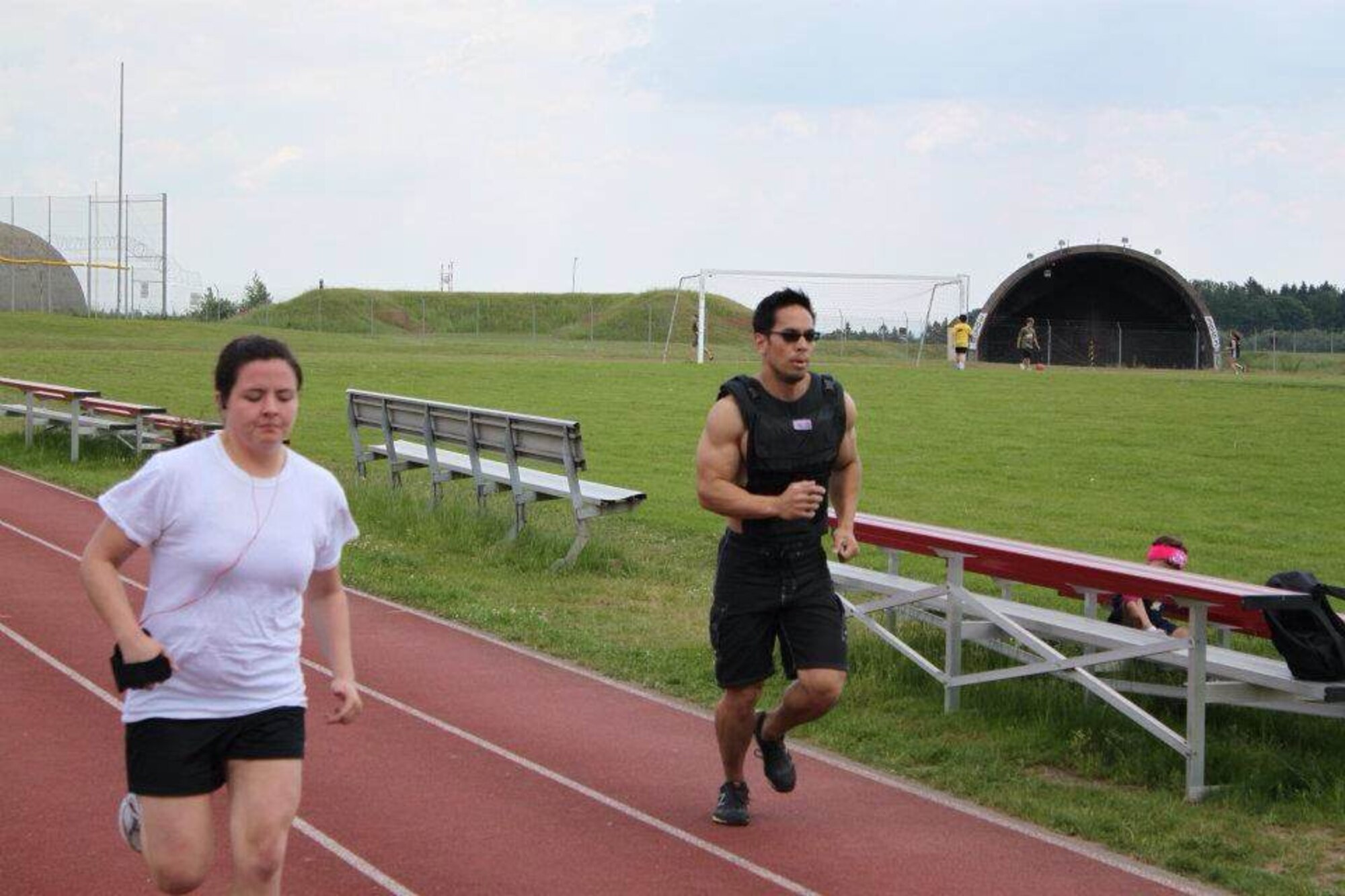U.S. Air Force Staff Sgt. Pamela Lozano, 52nd Logistics Readiness Squadron NCO in charge of personal property from Straudsburg, Pa., left, runs around the track at Spandahlem Air Base, Germany, in 2012 prior to changing her lifestyle and dedicating herself to healthy living. During the following two years, Lozano changed her diet, quit smoking and lost 25 pounds. (Courtesy photo/Released)