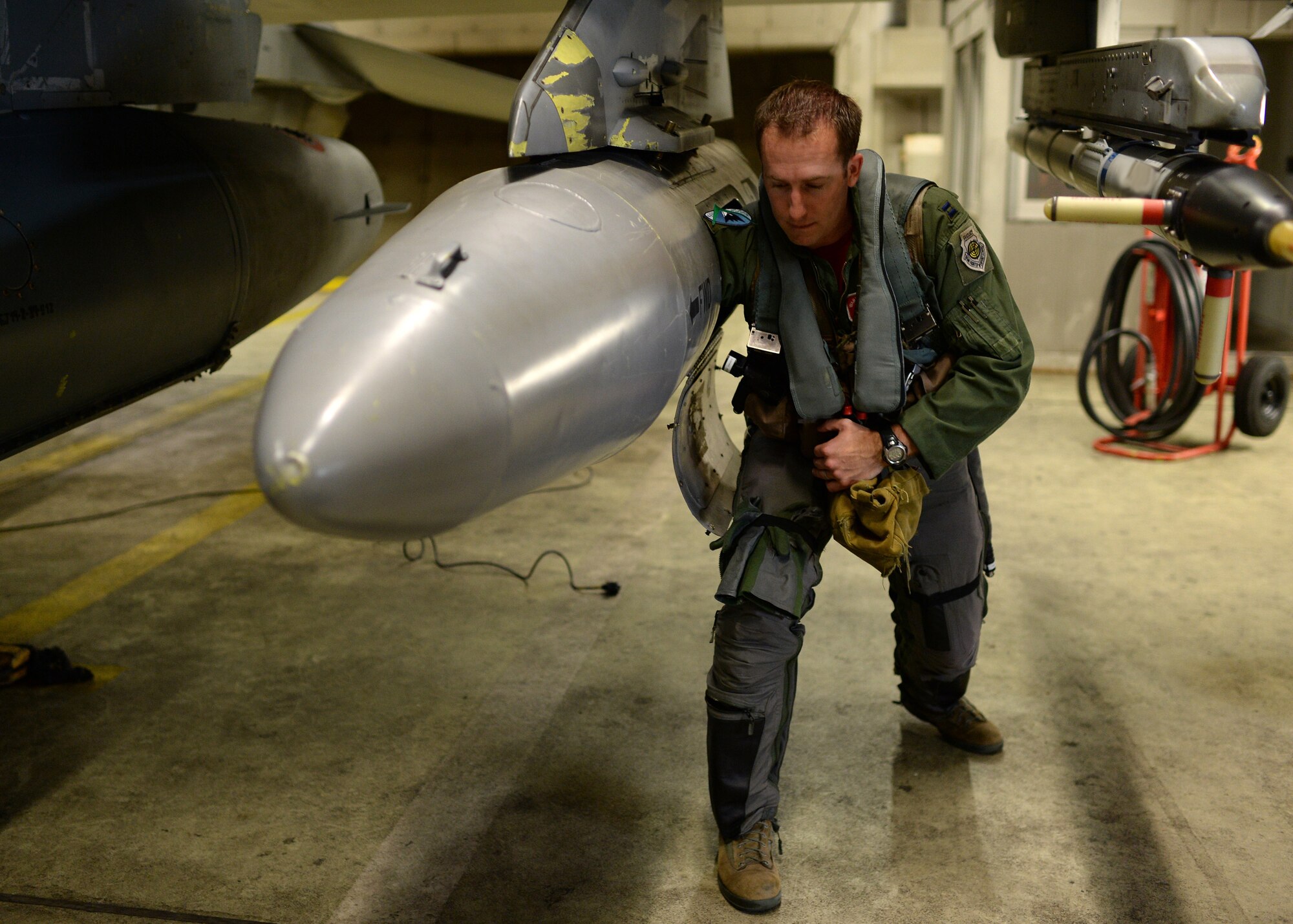 U.S. Air Force Capt. Taylor Blevins, a U.S. Air Force F-16 Fighting Falcon fighter aircraft pilot from the 480th Fighter Squadron at Spangdahlem Air Base, Germany, loads his gear into a pod Aug. 8, 2014, before flying to a training event with the Hellenic air force in Souda Bay, Greece, Aug. 11-23. These types of training events aim to build relationships and capabilities of NATO allies. (U.S. Air Force photo by Staff Sgt. Daryl Knee/Released)