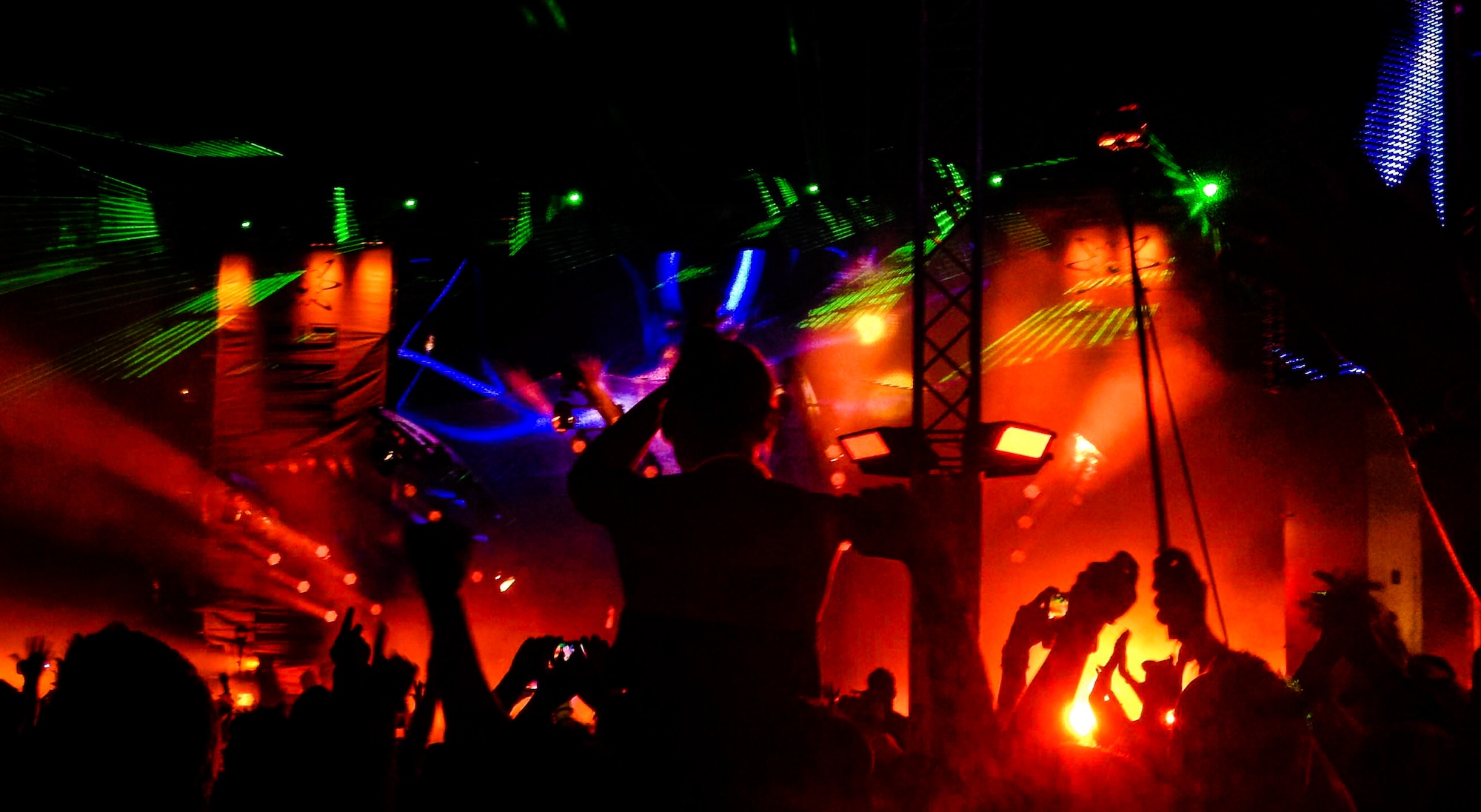 A festival attendee sits on the shoulders of a friend during a musical performance Aug. 3, 2014, 2014, inside the former Pydna Missile Base, Germany.  Day two of the German dance music festival saw major international entertainers drawing in an expected 72,000 attendees. (U.S. Air Force photo/Airman 1st Class Jordan Castelan)