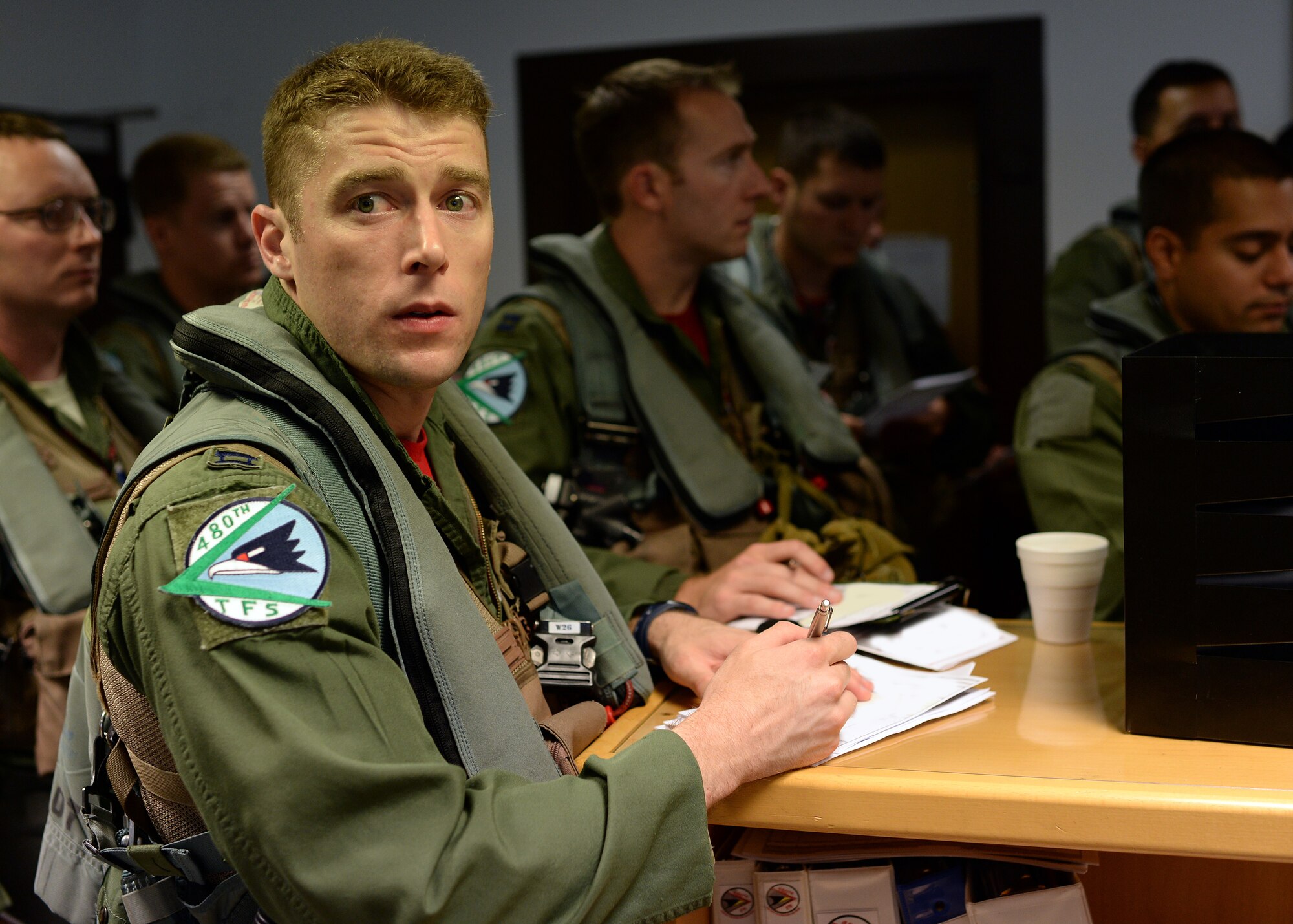 A U.S. Air Force F-16 Fighting Falcon fighter aircraft pilot from the 480th Fighter Squadron at Spangdahlem Air Base, Germany, reviews his flight information before departing for Souda Bay, Greece, for a training event between the U.S. and Hellenic air forces Aug. 11-23. The goal of the training event is to strengthen the ties between the two nations and increase their NATO military capability. (U.S. Air Force photo by Staff Sgt. Daryl Knee/Released)