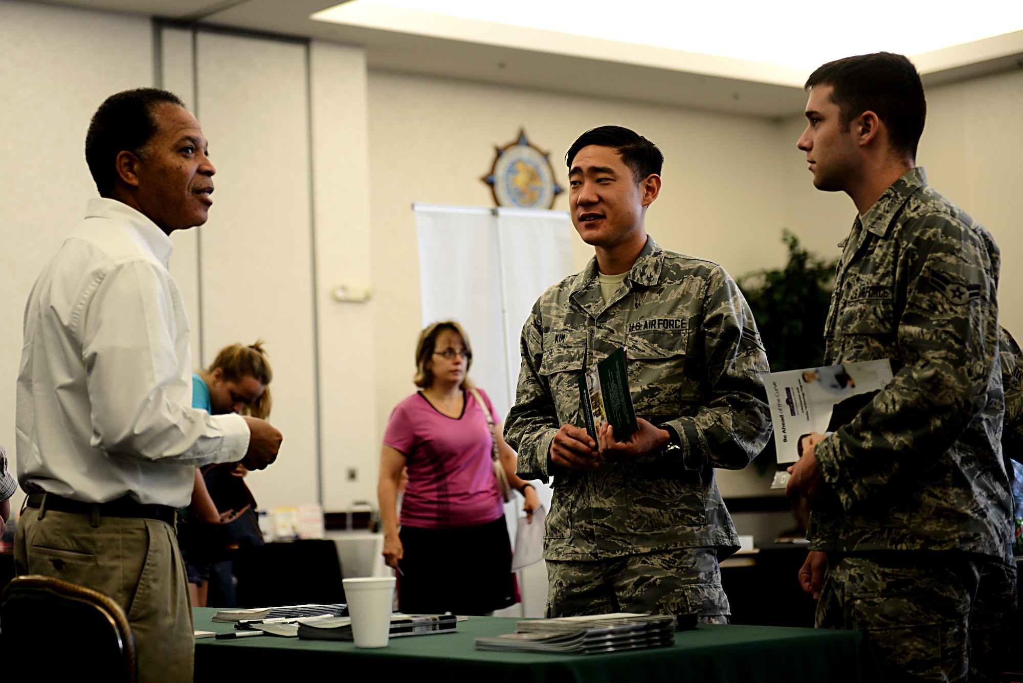 Servicemembers who are looking for a higher education talk to a representative from Washington University in St. Louis at the “The Future is Now” Education Fair at the Scott Club Aug. 6, 2014. College and university representatives were on hand to personally speak to attendees regarding degree specific courses, financial aid, school specific scholarships and grants, and how use of GI Bill benefits may allow members to attend college at the lowest cost possible. (U.S. Air Force photo/Senior Airman Jake Eckhardt)
