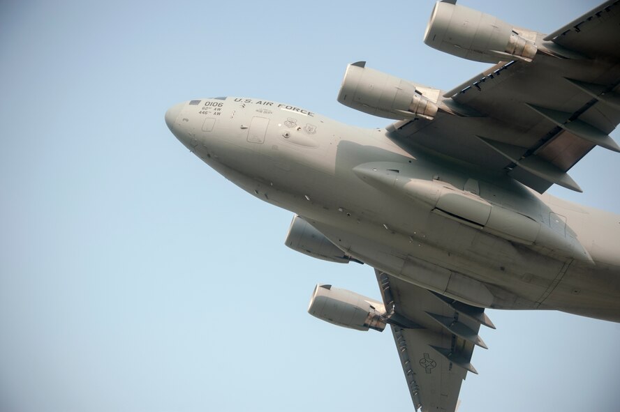 A C-17 Globemaster III transporting Wolf Pack Airmen to RED FLAG-Alaska 14-3 takes off at Kunsan Air Base, Republic of Korea, Aug. 5, 2014. This exercise provides joint offensive counter-air, interdiction, close-air support and large-force employment training in a simulated combat environment. (U.S. Air Force photo by Senior Airman Taylor Curry/Released)